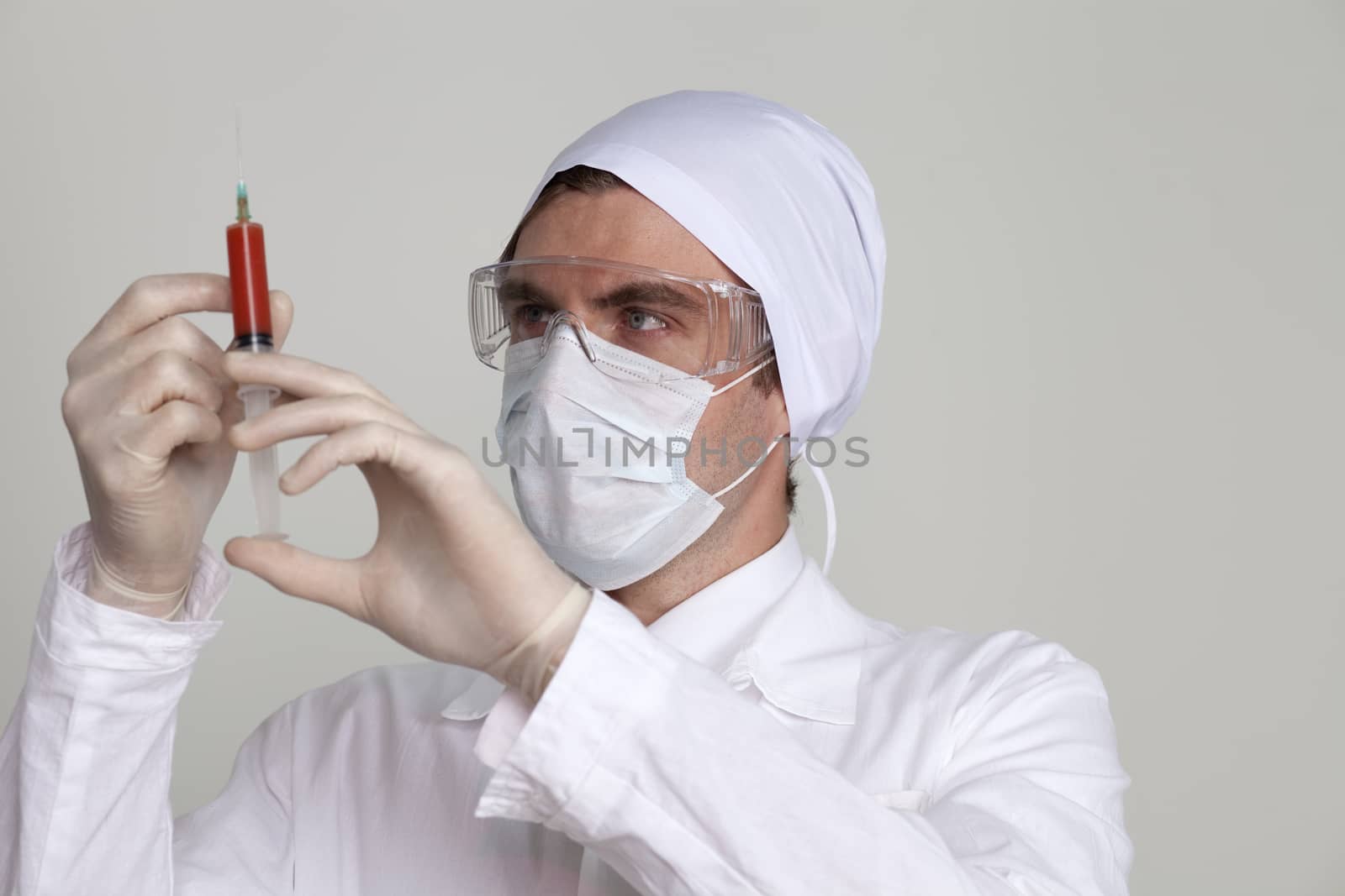 Confident surgeon holding a syringe by andersonrise