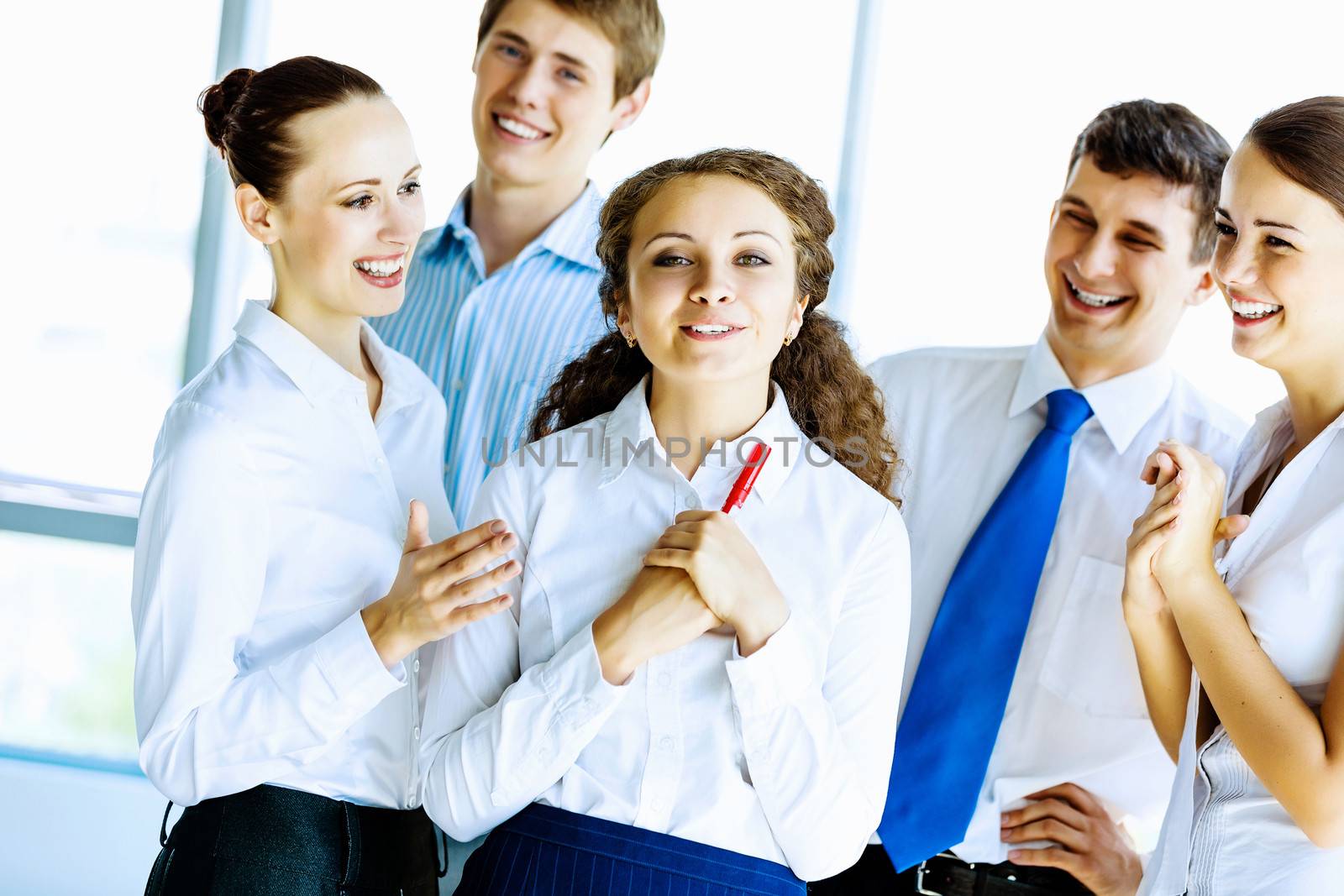 Image of young businesspeople congratulating colleague. Success concept