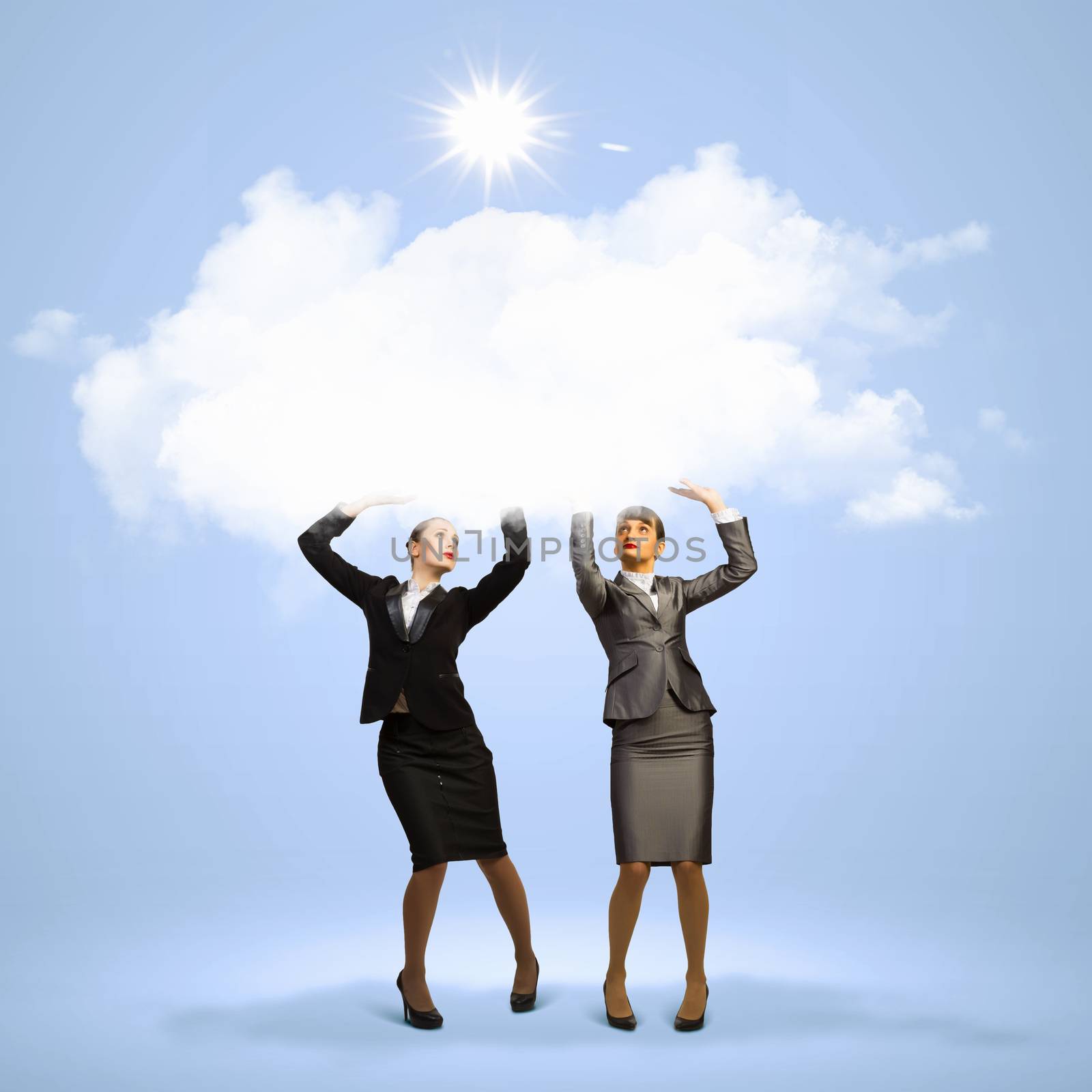 Image of two businesswomen holding clouds above head