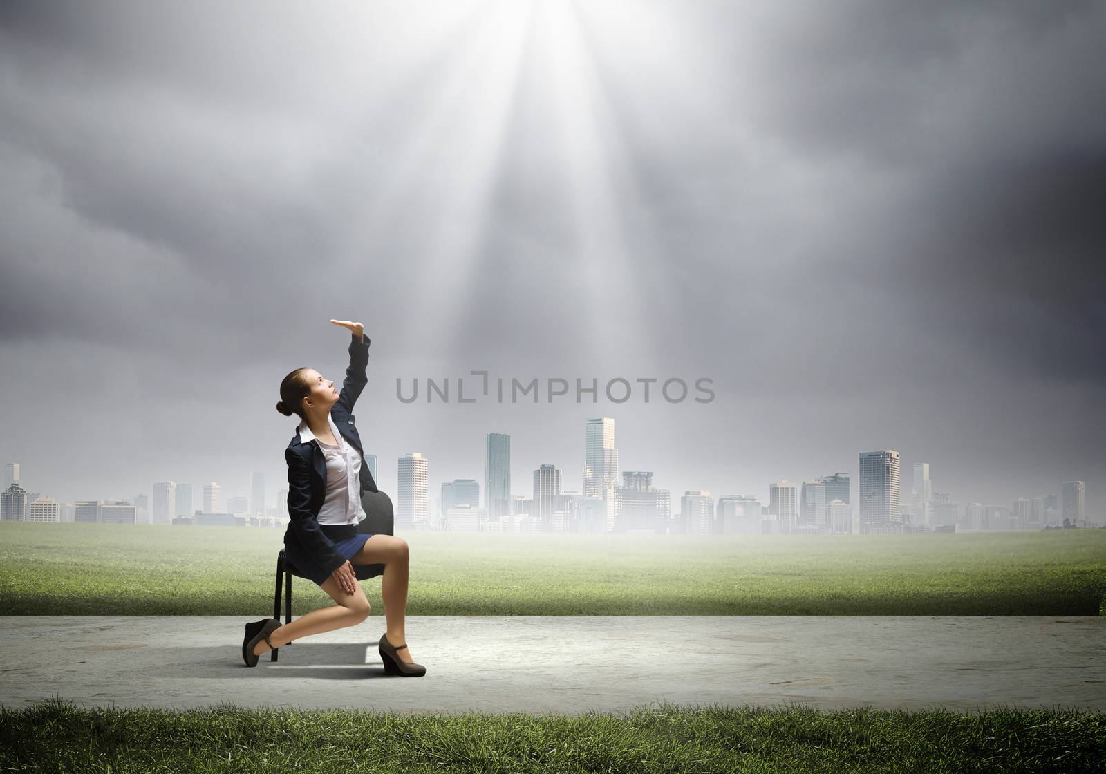 Image of businesswoman sitting on chair under sun lights