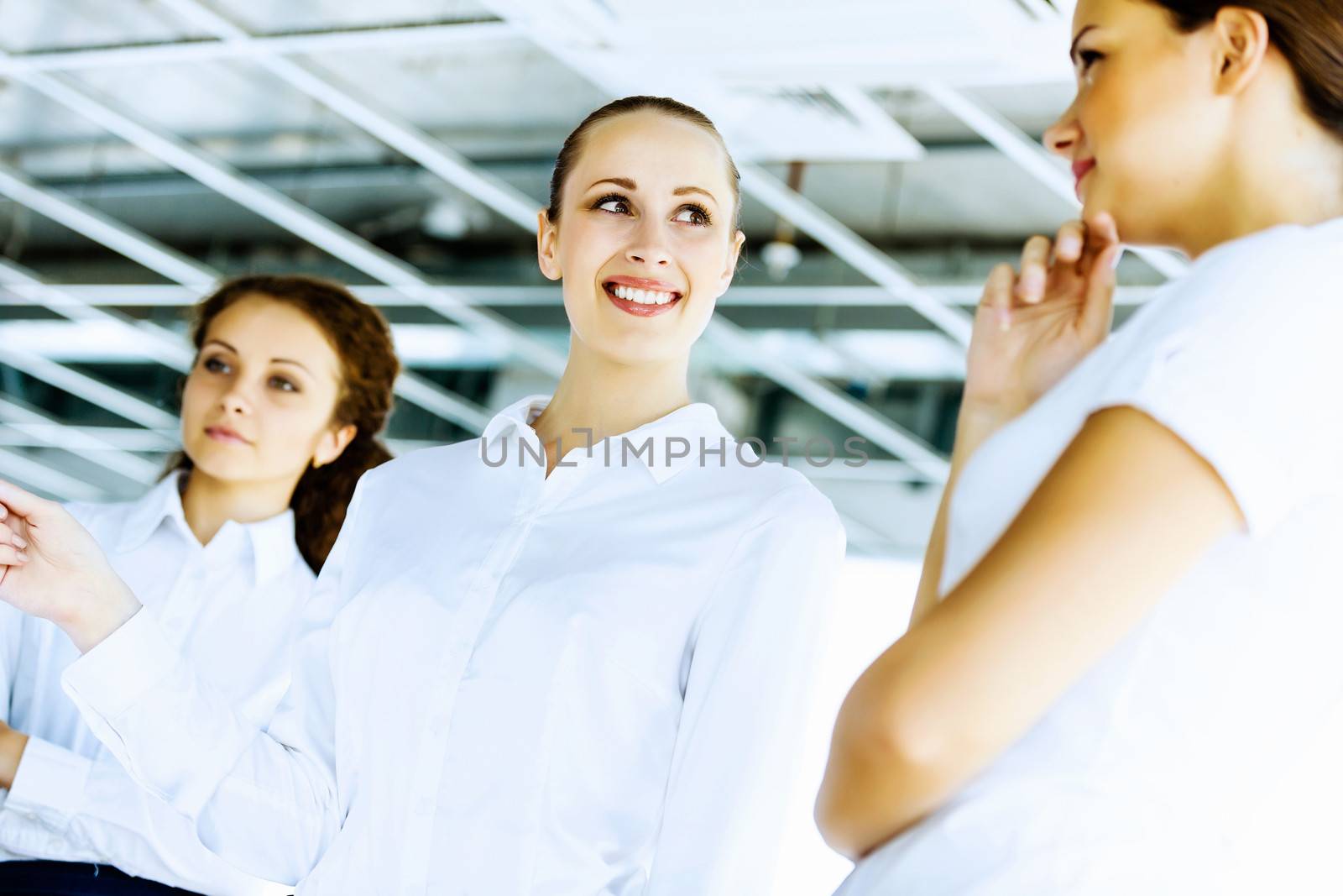 Image of three young businesswomen at meeting