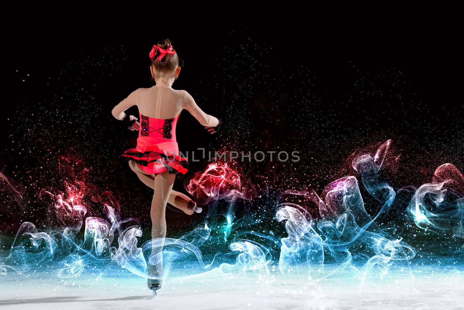 Little girl figure skating at sports arena