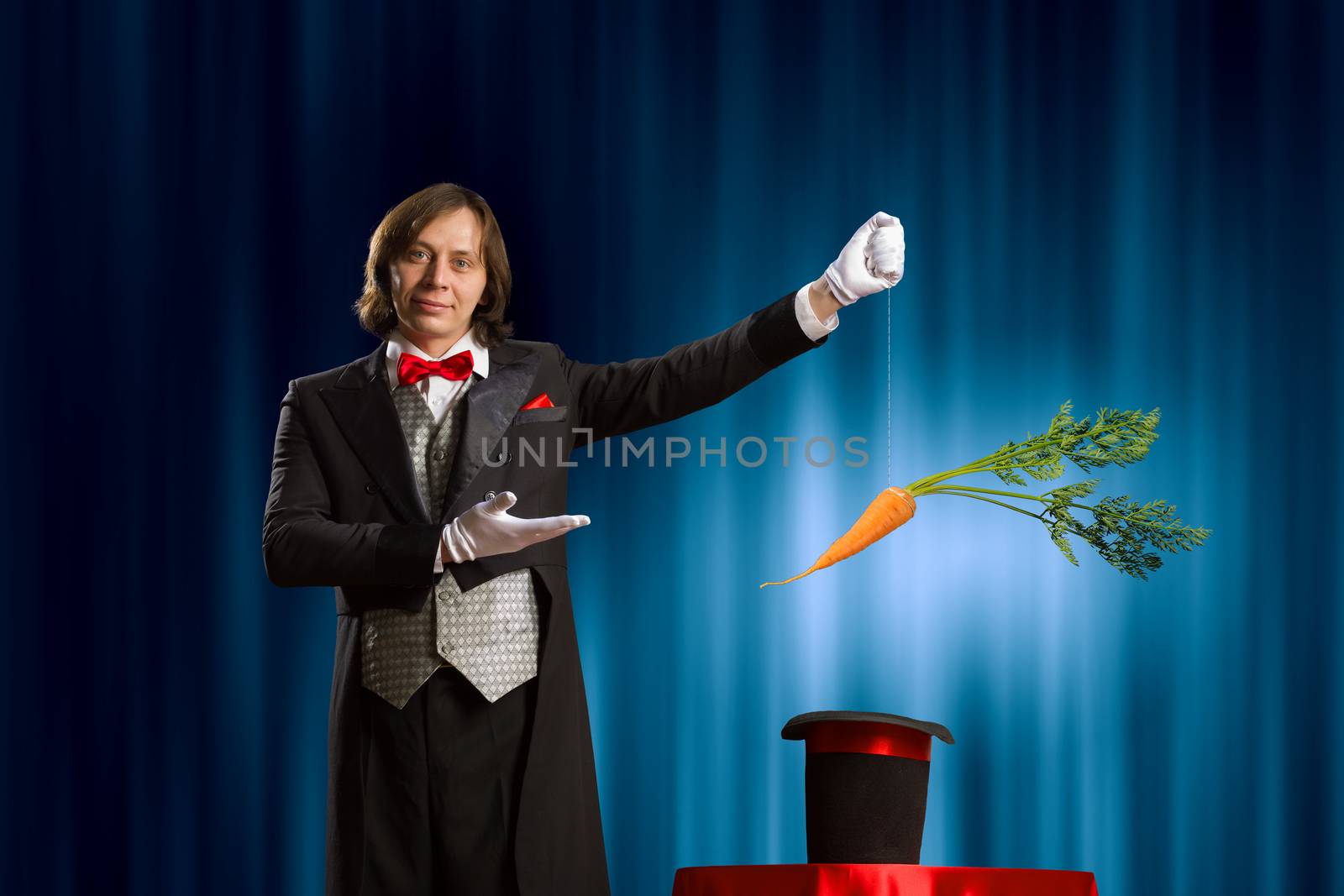 Image of magician taking carrot out of magic hat