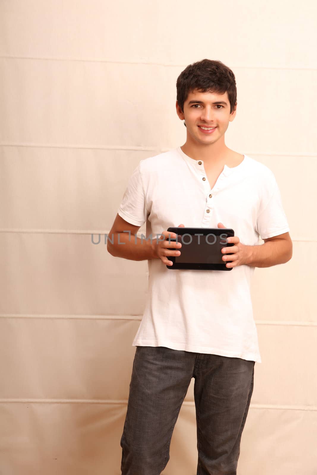 A young, latin man with a Tablet PC, face in focus
