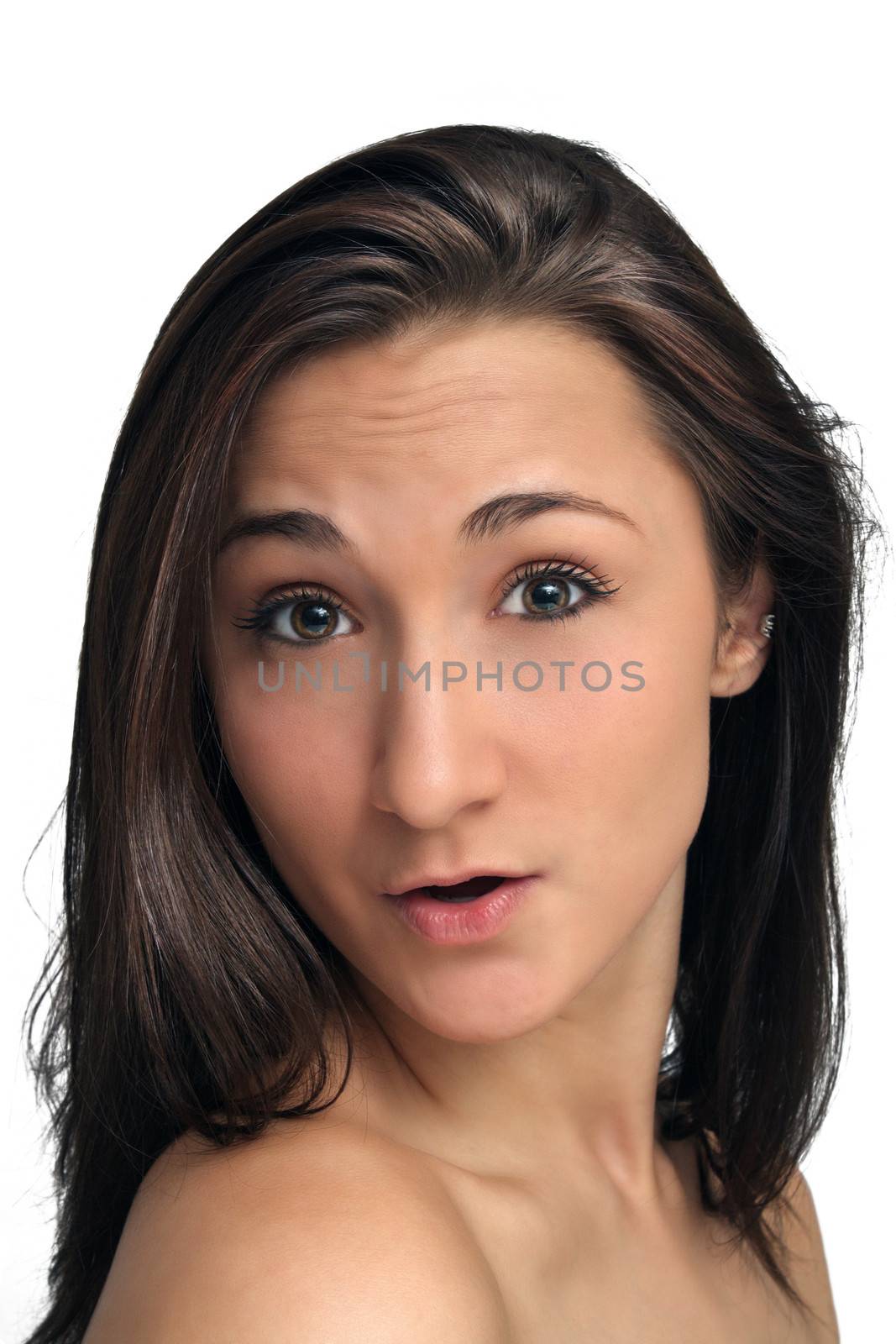 A studio close-up of a lovely young brunette with an excited or surprised facial expression.