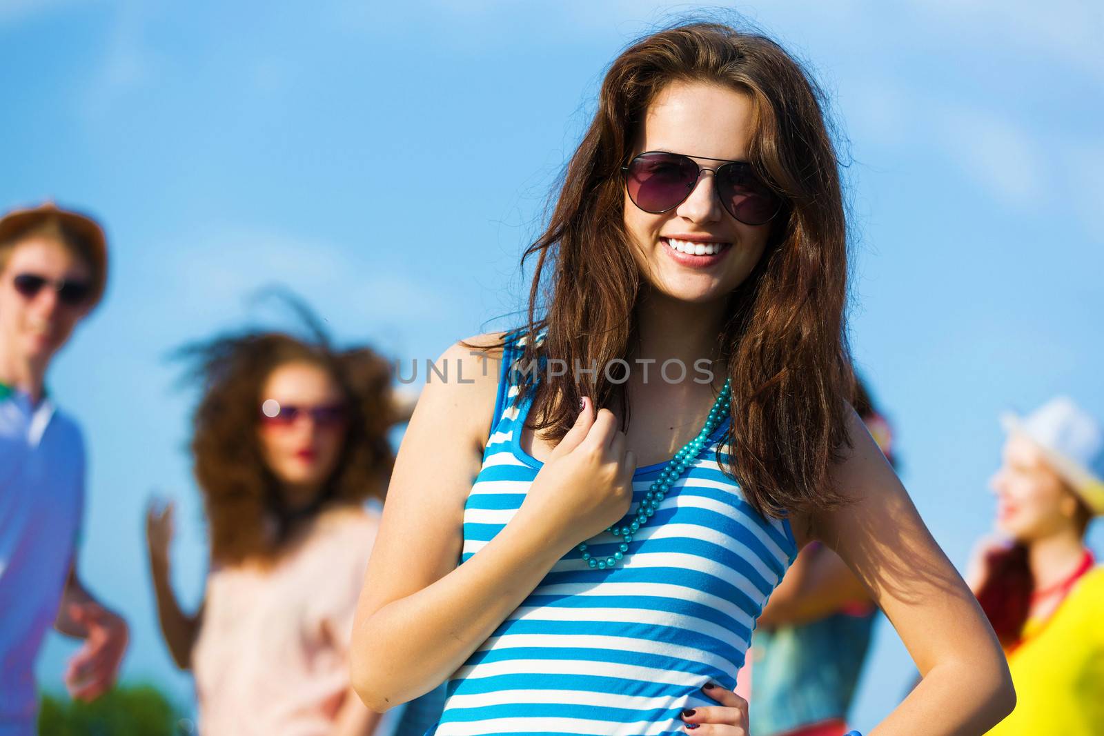 Image of young attractive woman with friends at background