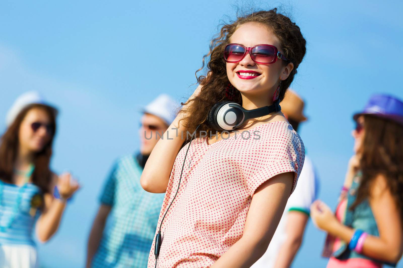 Image of young attractive woman with friends at background