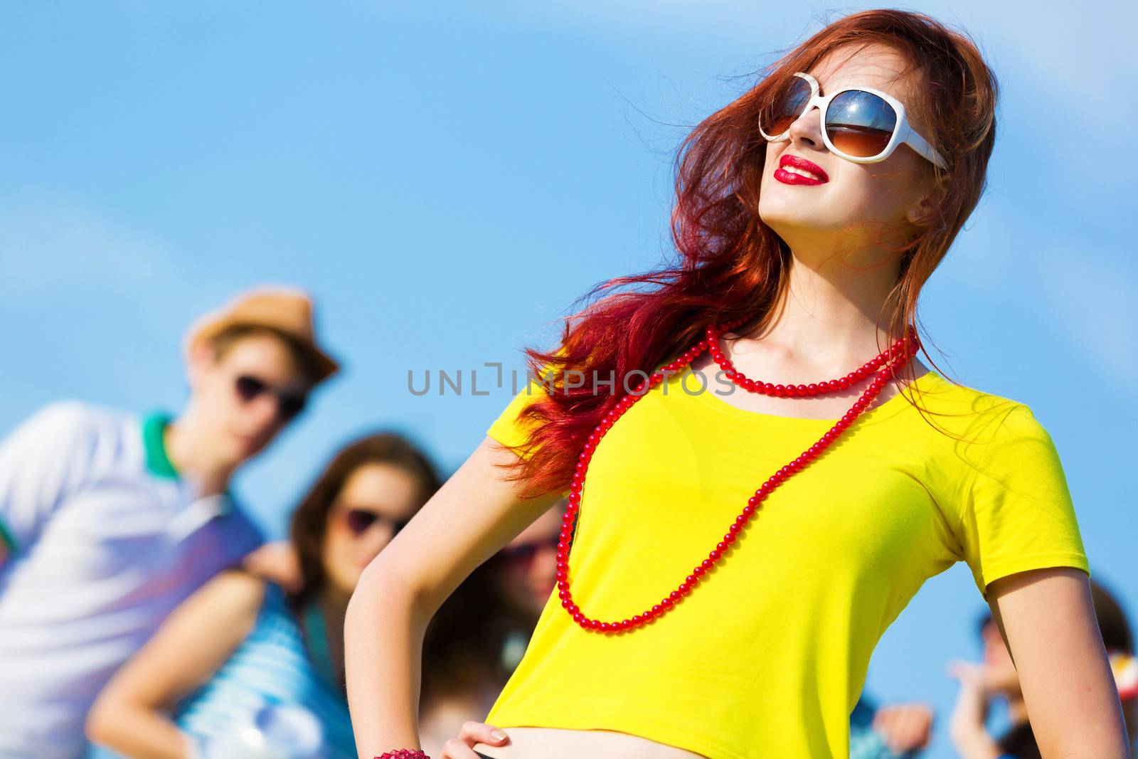 Image of young attractive woman with friends at background