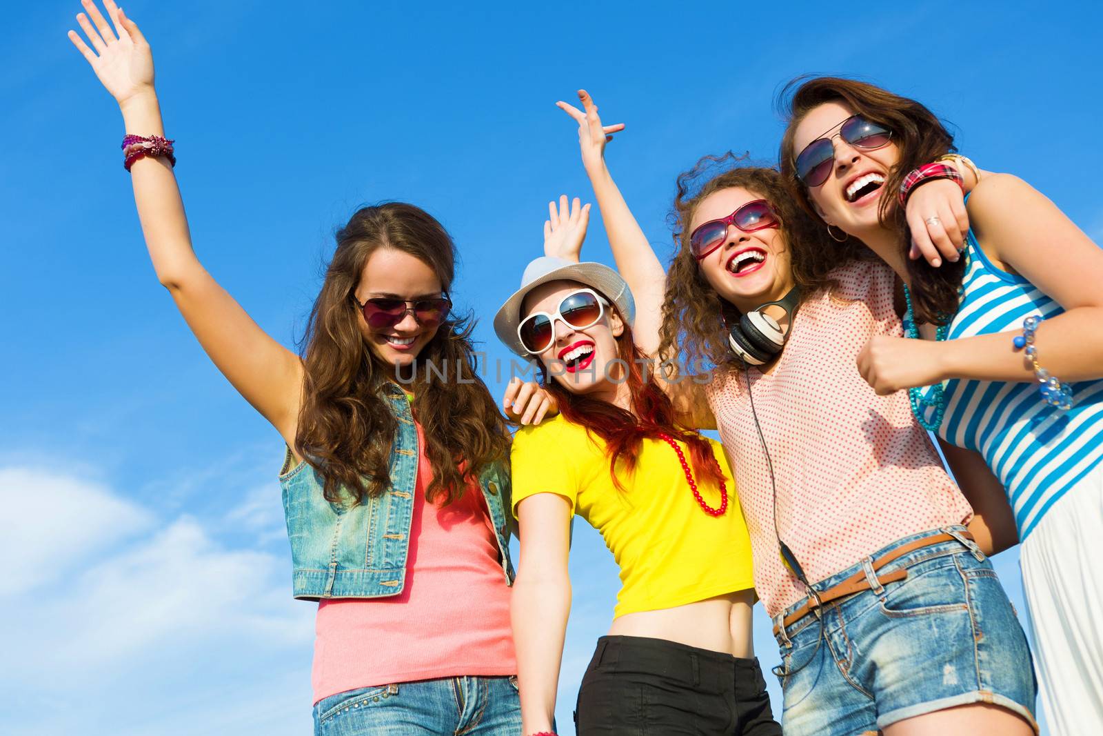 Image of four young attractive girls having fun outdoors