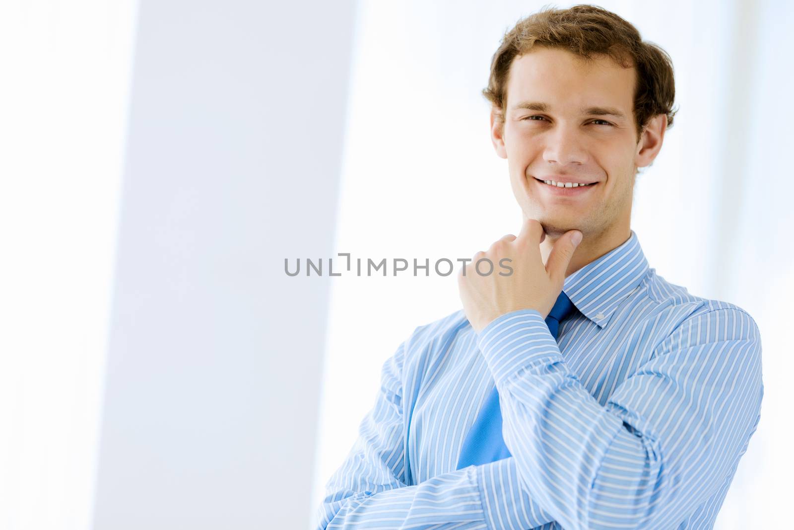 Image of young handsome confident businessman in suit