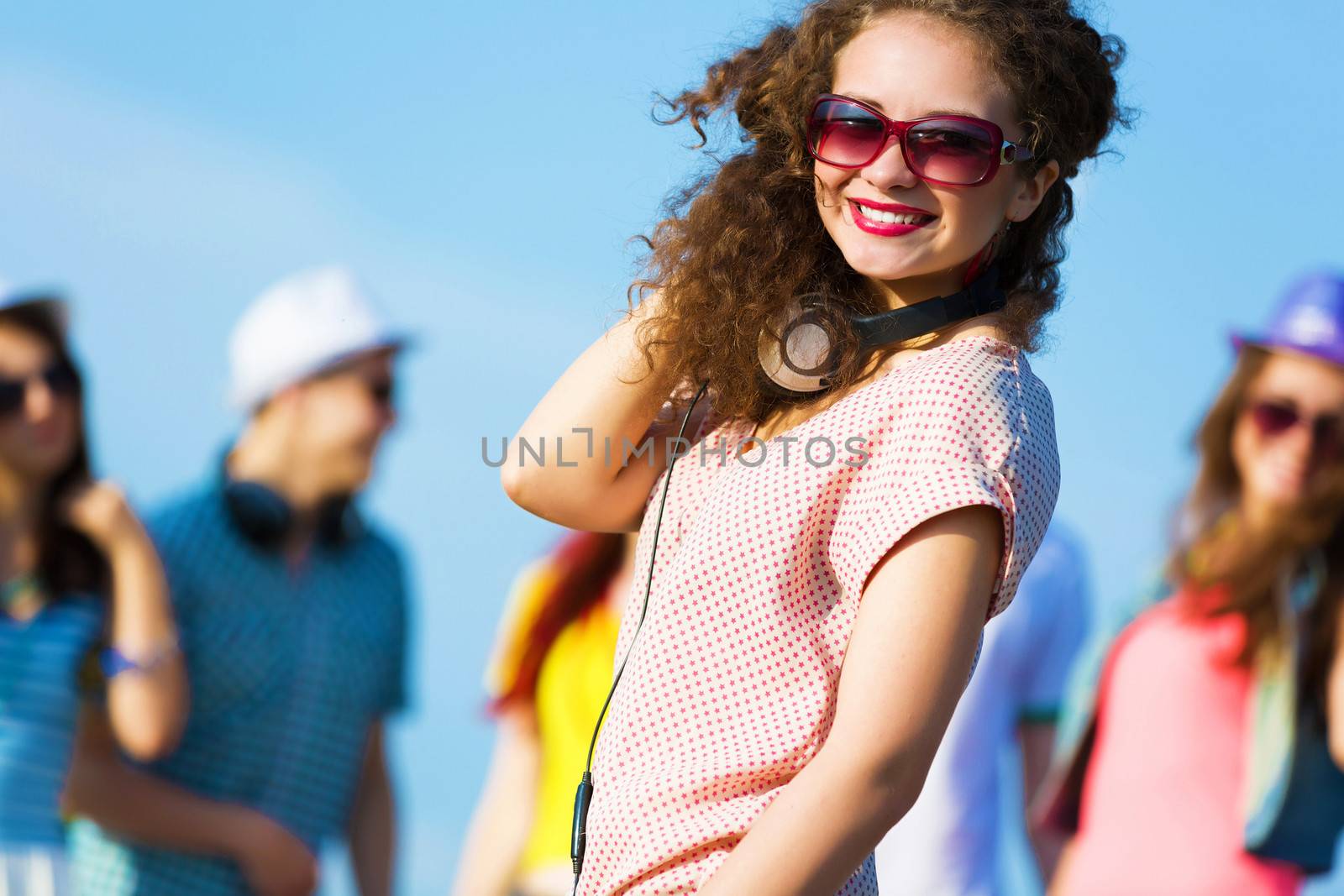 Image of young attractive woman with friends at background