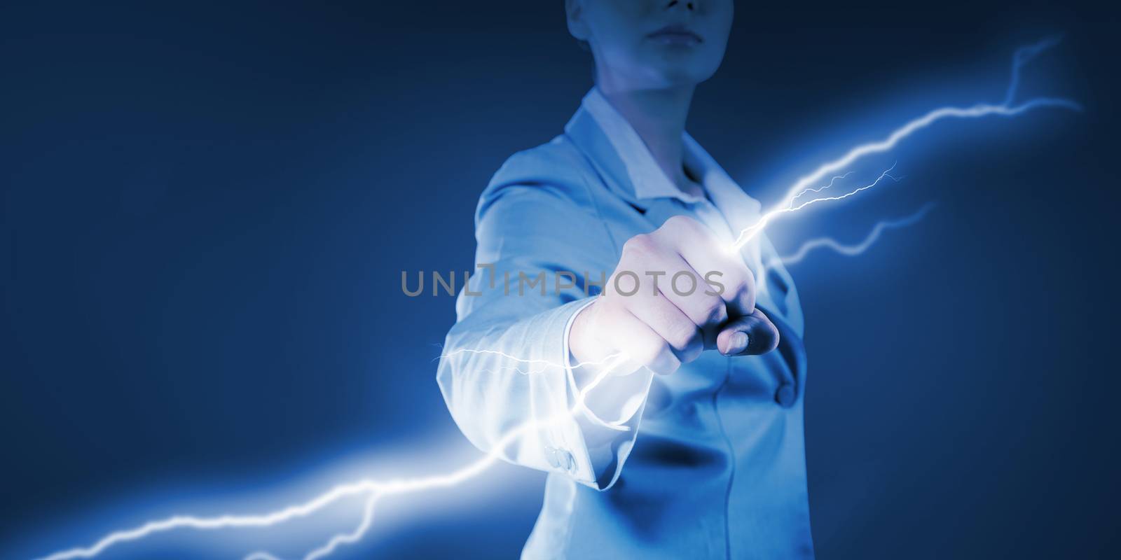 Image of powerful businesswoman holding lightning in fist