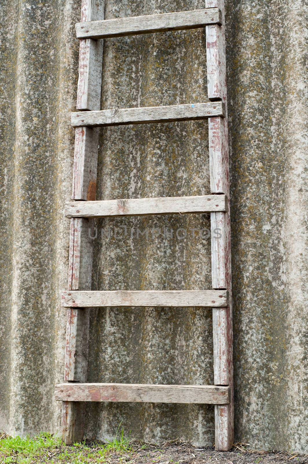 wooden ladder near old roofing slate by mycola