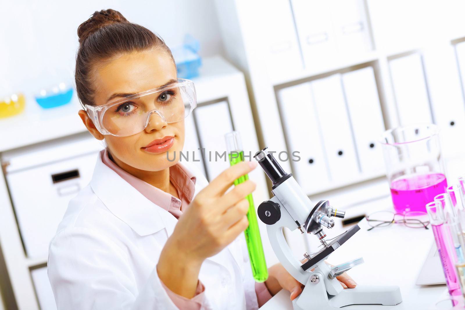 Young female scientist working in laboratory by sergey_nivens