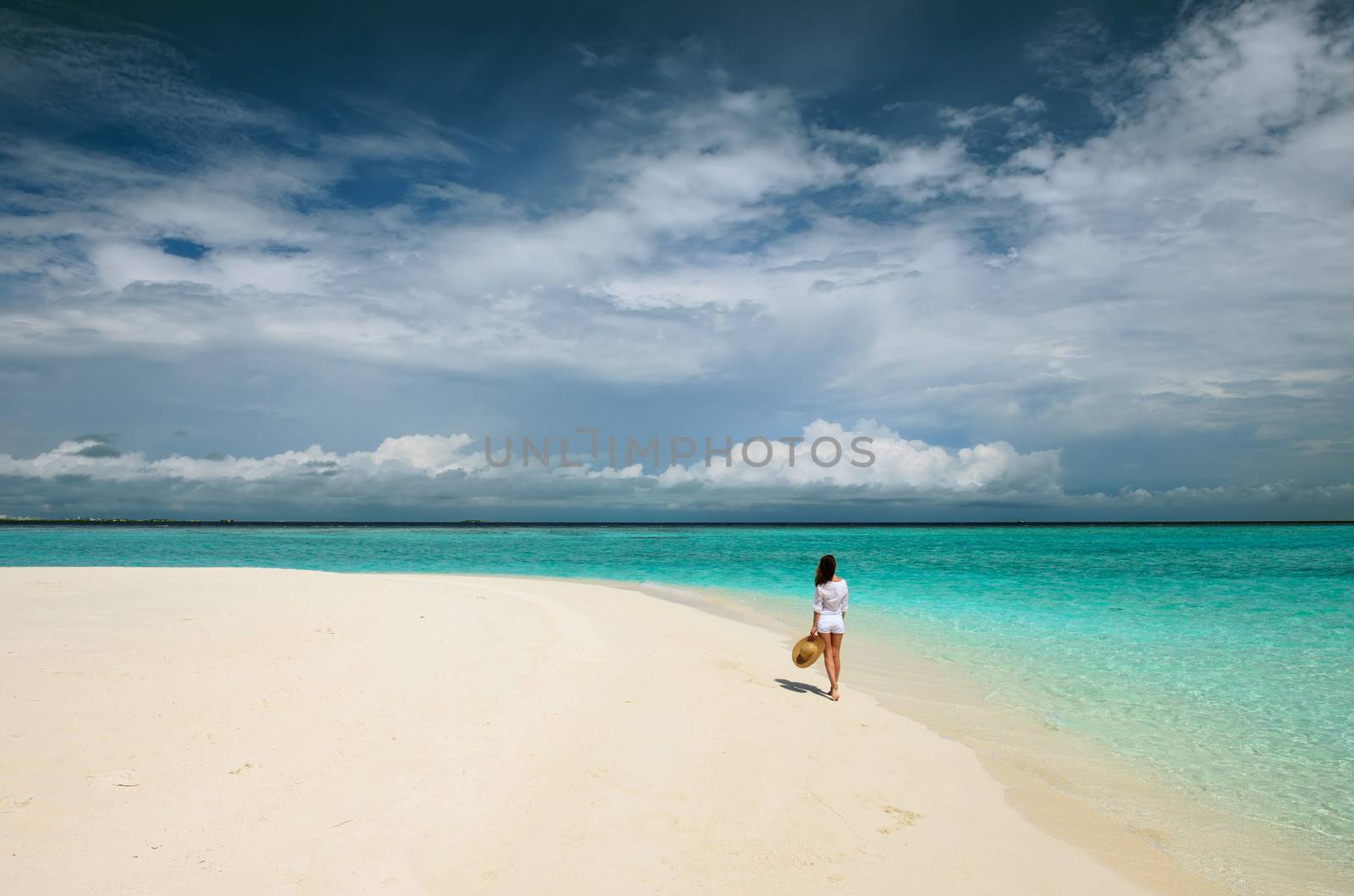 Woman in sun hat at tropical beach