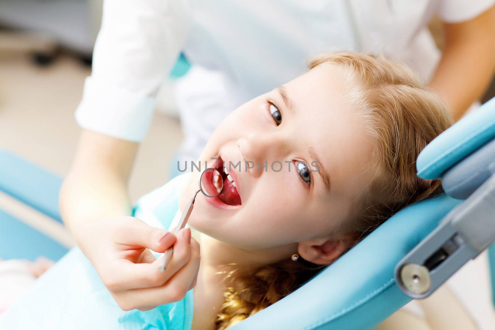 Little girl visiting dentist by sergey_nivens