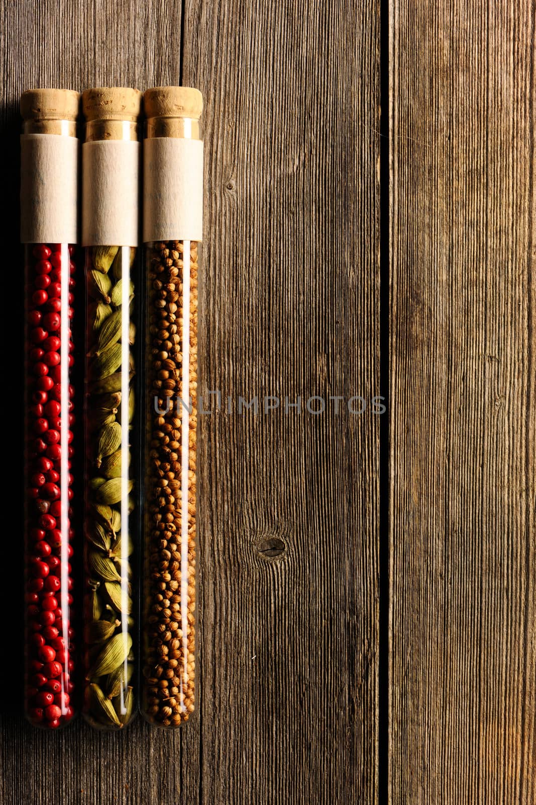 Spices in beakers on wooden table by haveseen