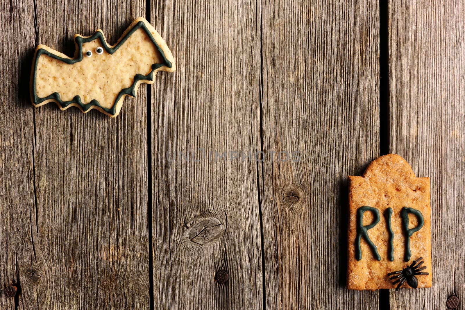 Halloween homemade gingerbread cookies over wooden table