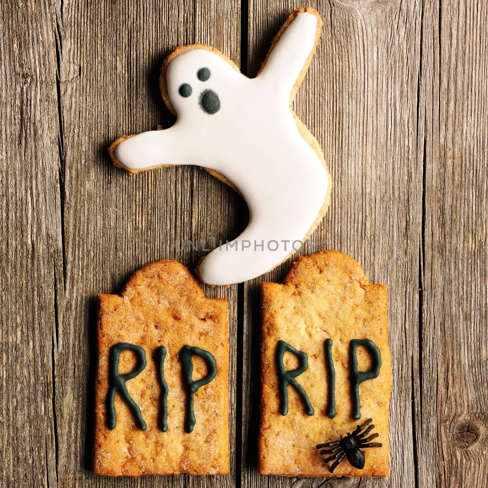 Halloween homemade gingerbread cookies over wooden table