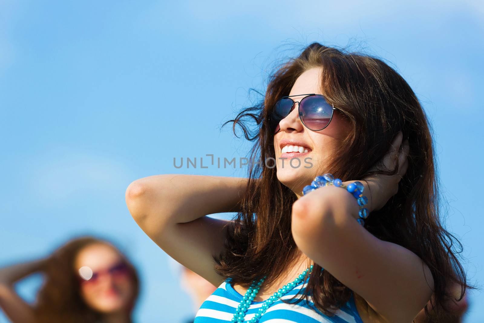 Image of young attractive woman with friends at background