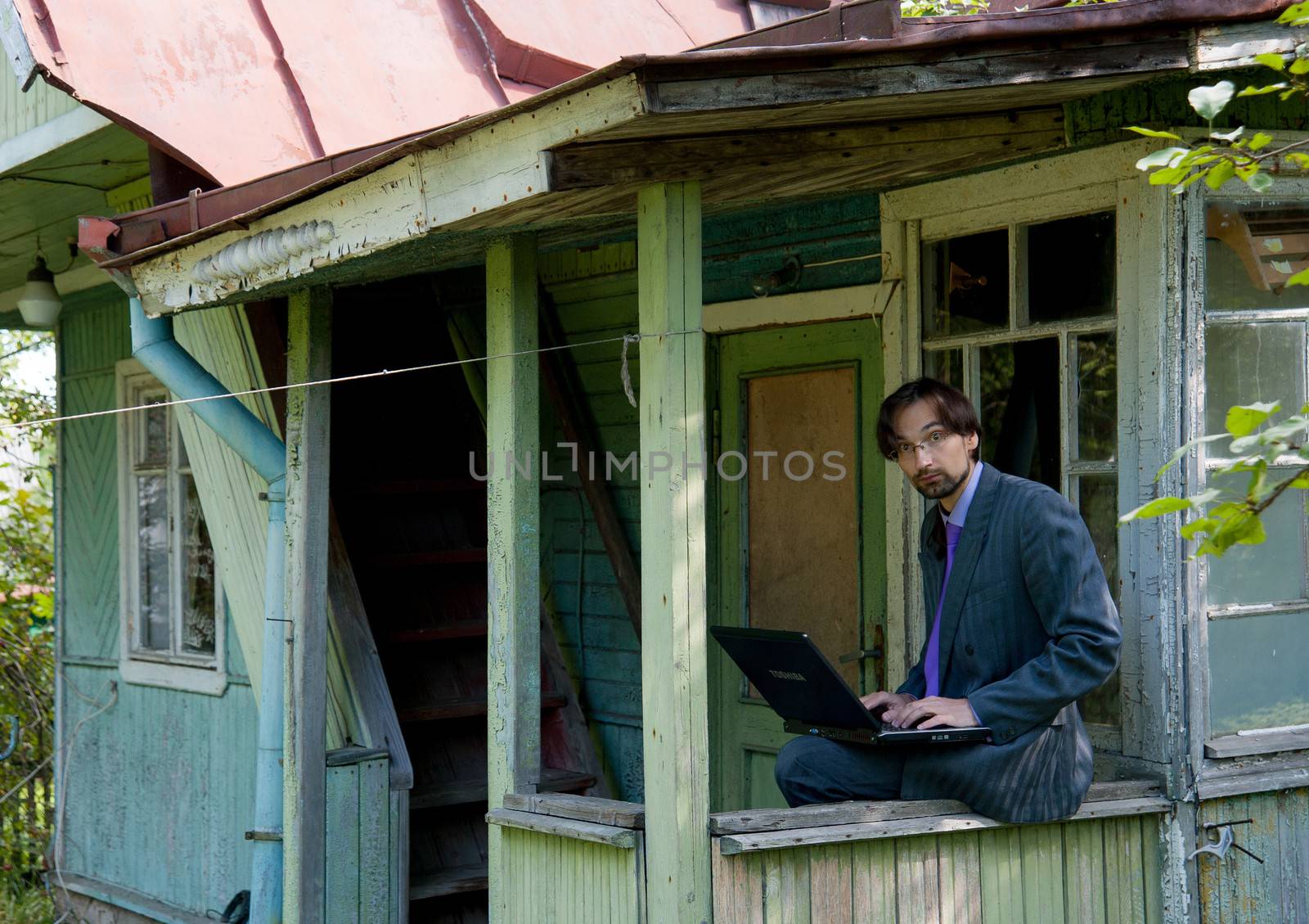 business man using laptop in the field by raduga21