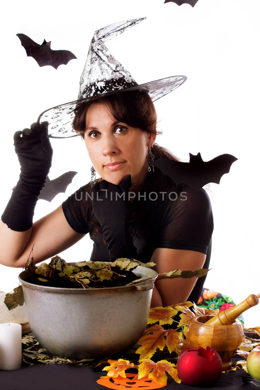 Witch making magic on Halloween isolated over white