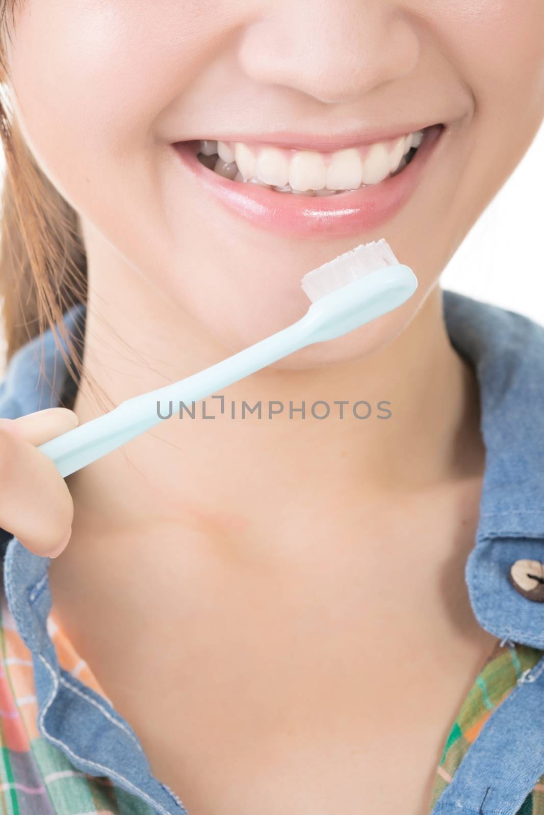 Closeup shot of asian woman brushing teeth with smiling.