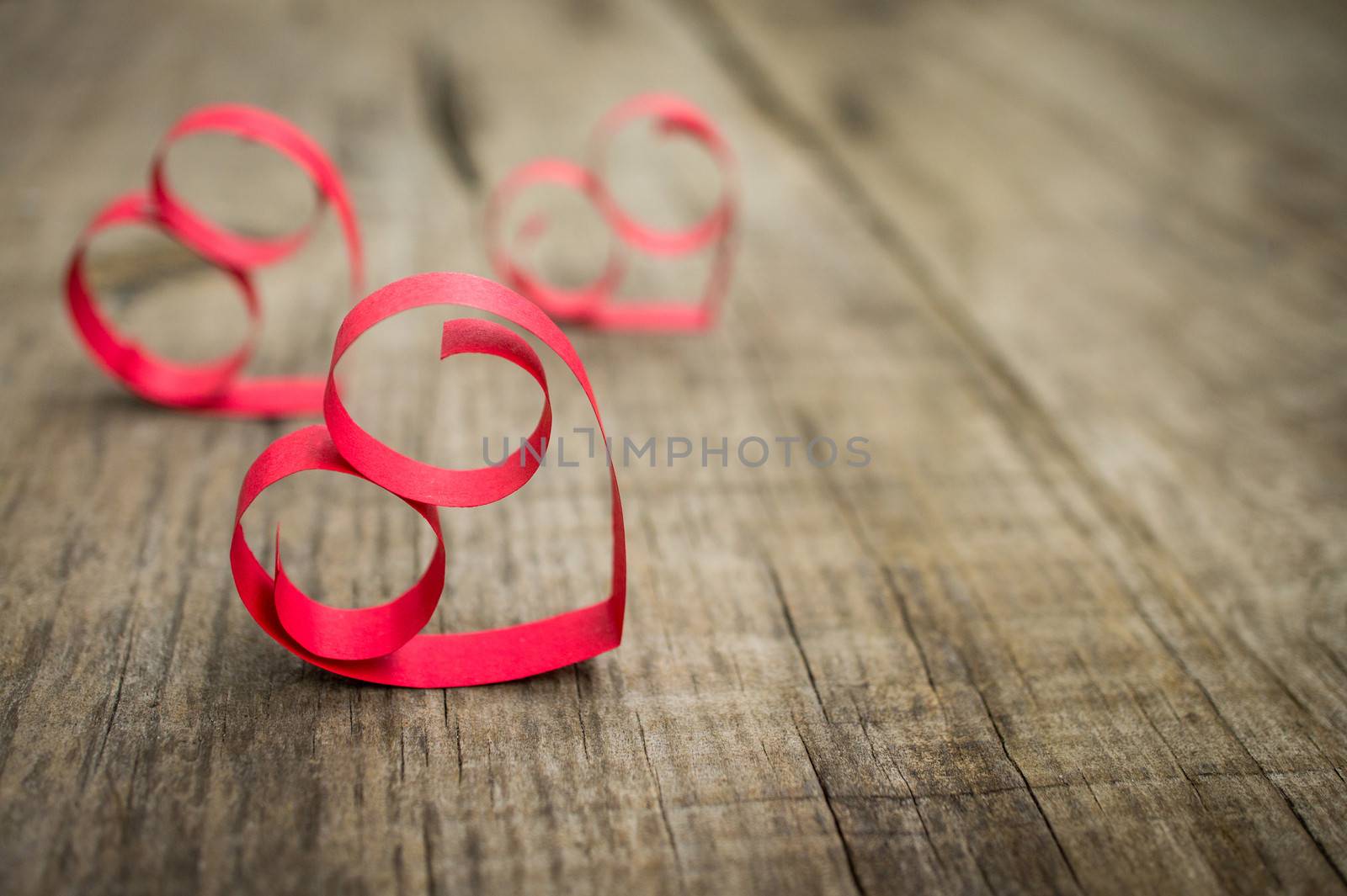 Paper Heart decoration on wooden textured background. 