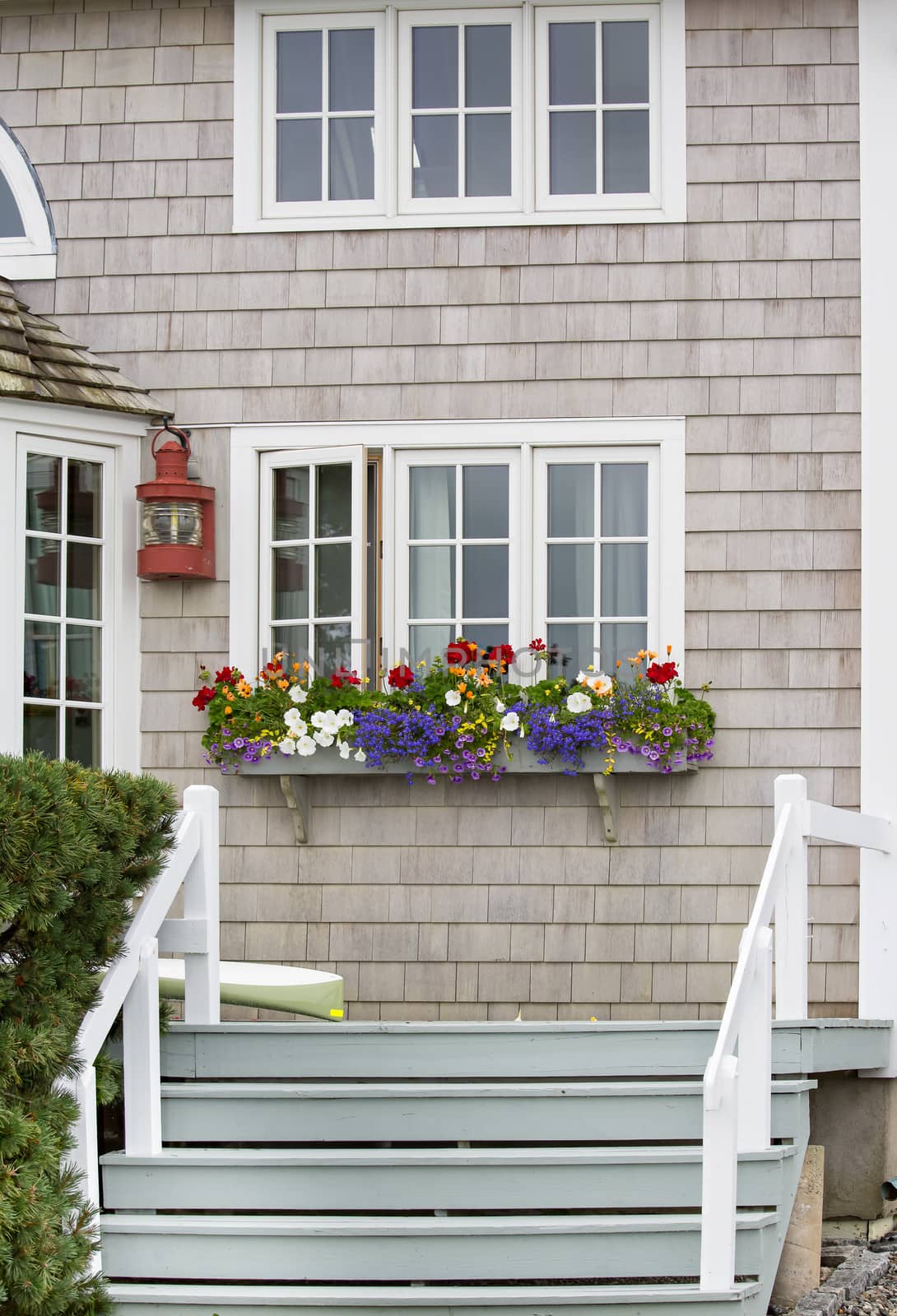 The entrance to this home is very friendly looking with the planter full of bright flowers.