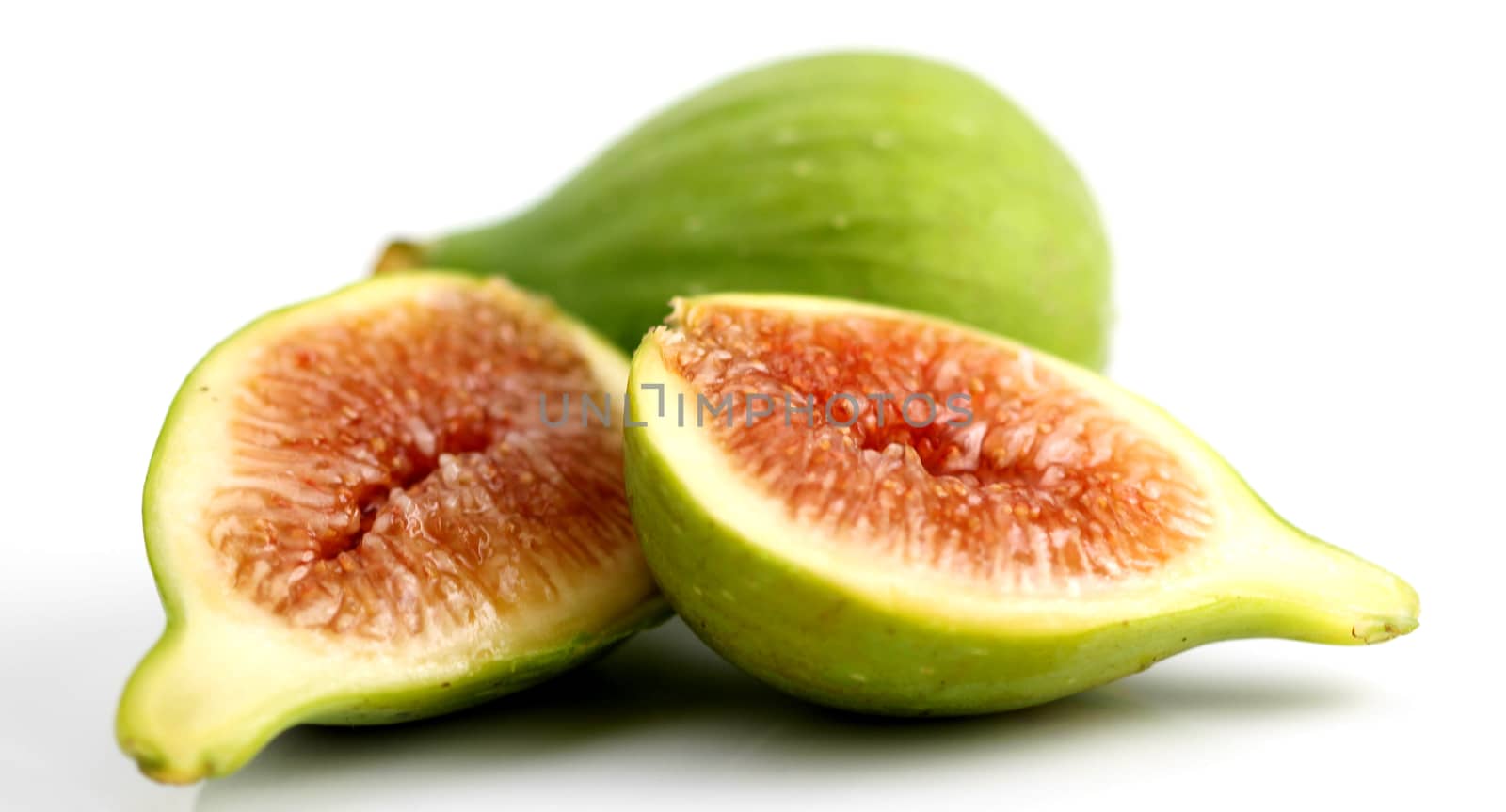 Green fig cut open on white background.