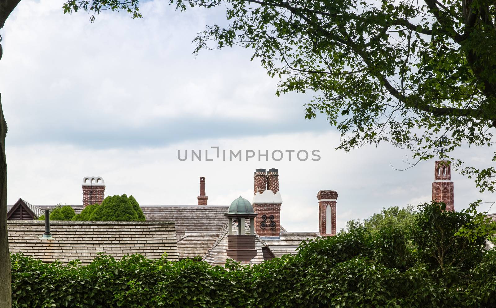 This older New England home sports numerous styles of chimneys.