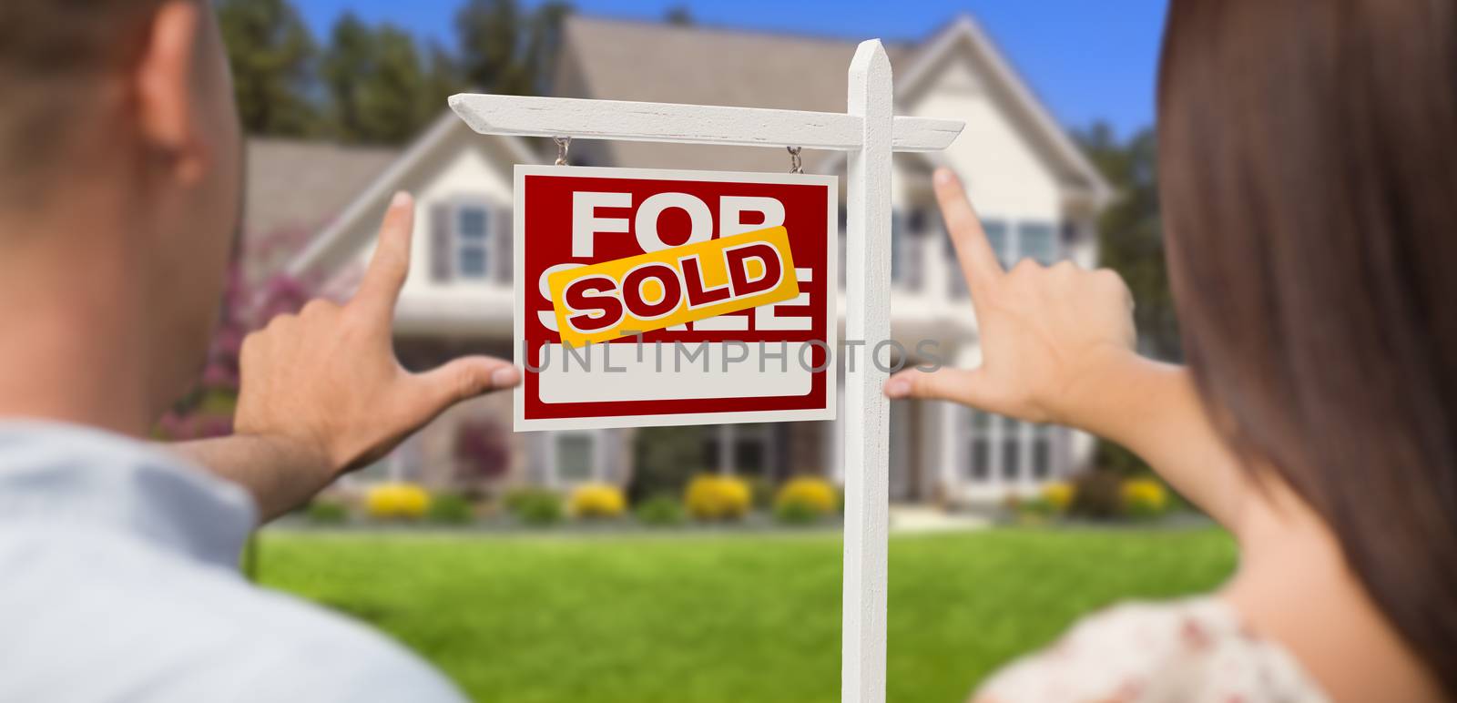 Sold For Sale Real Estate Sign, House and Military Couple Framing Hands in Front.