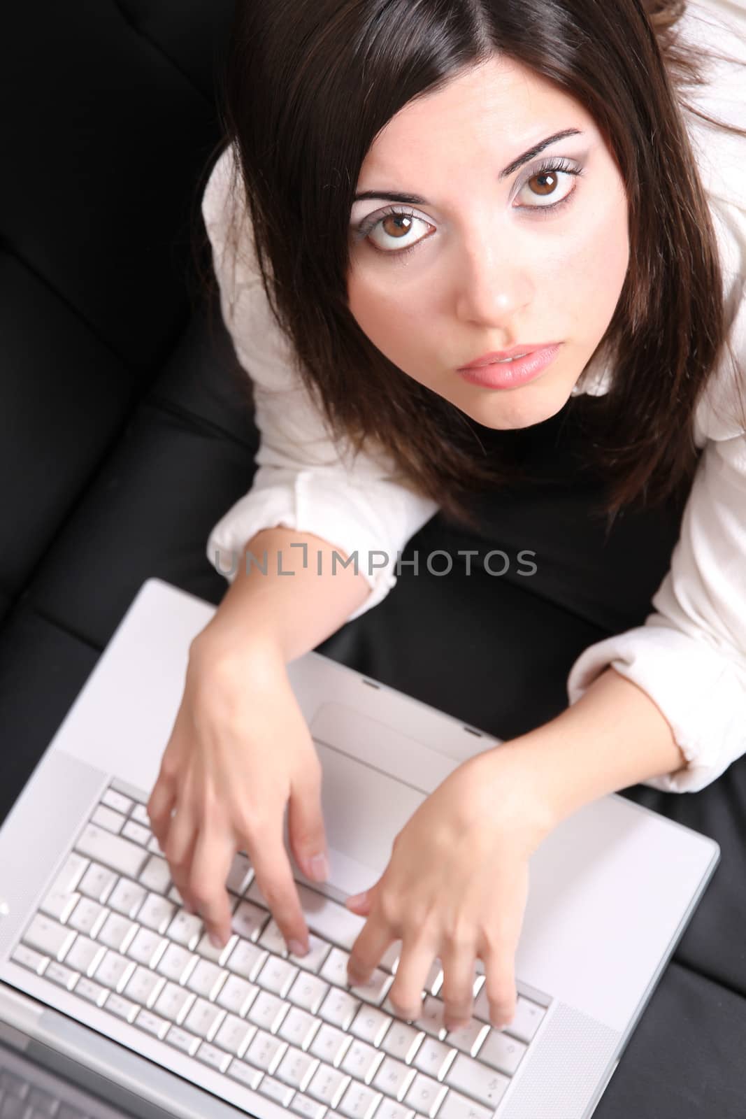 A young woman surfing on the Internet with a Laptop.  
