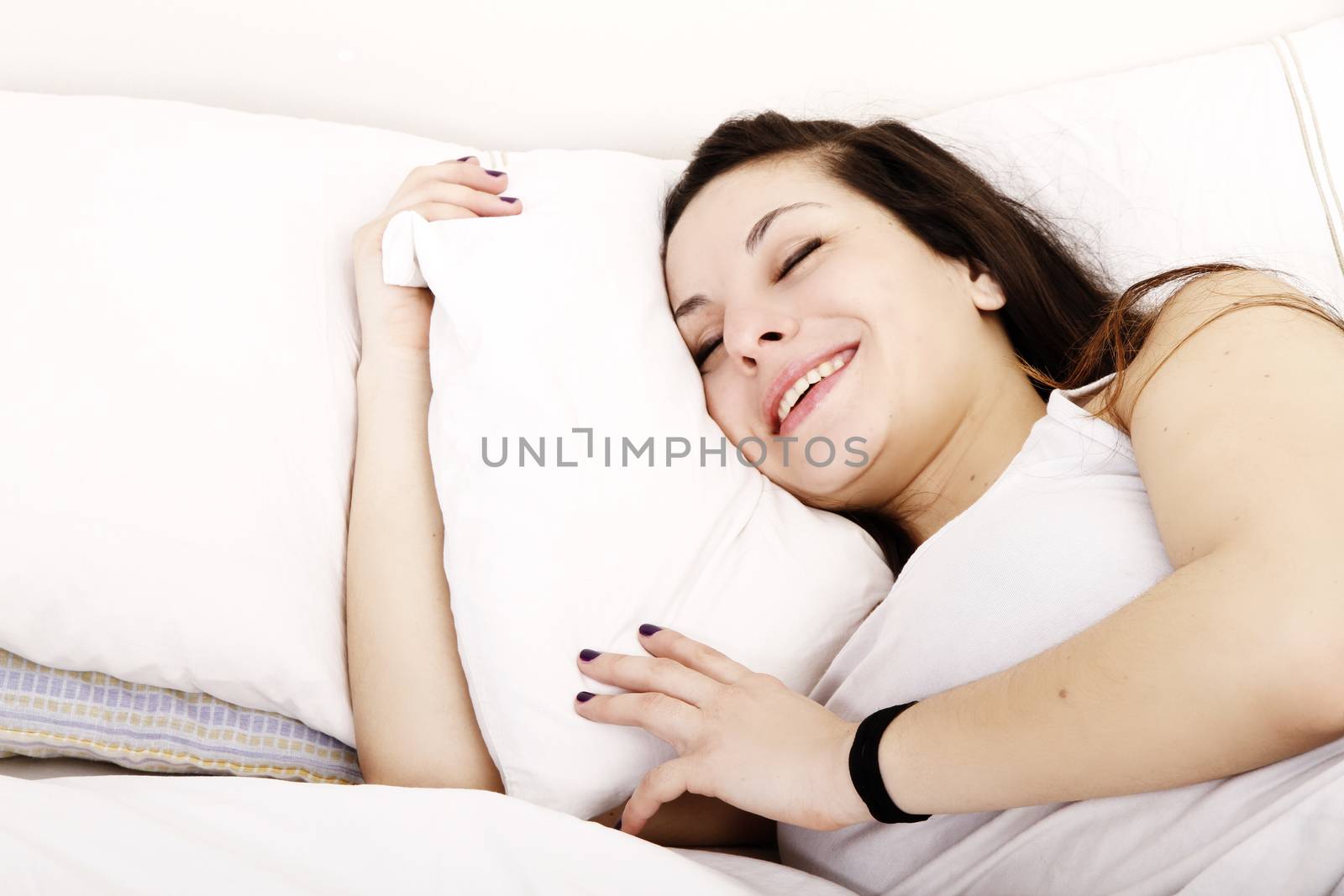 A young adult Woman relaxing on the Bed.