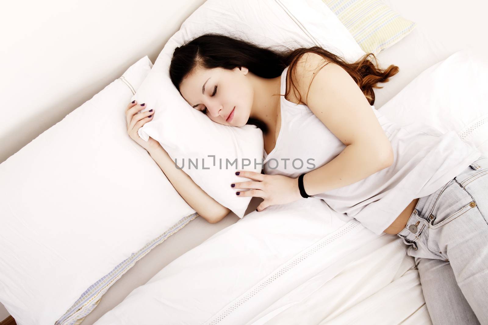 A young adult Woman sleeping on the Bed.