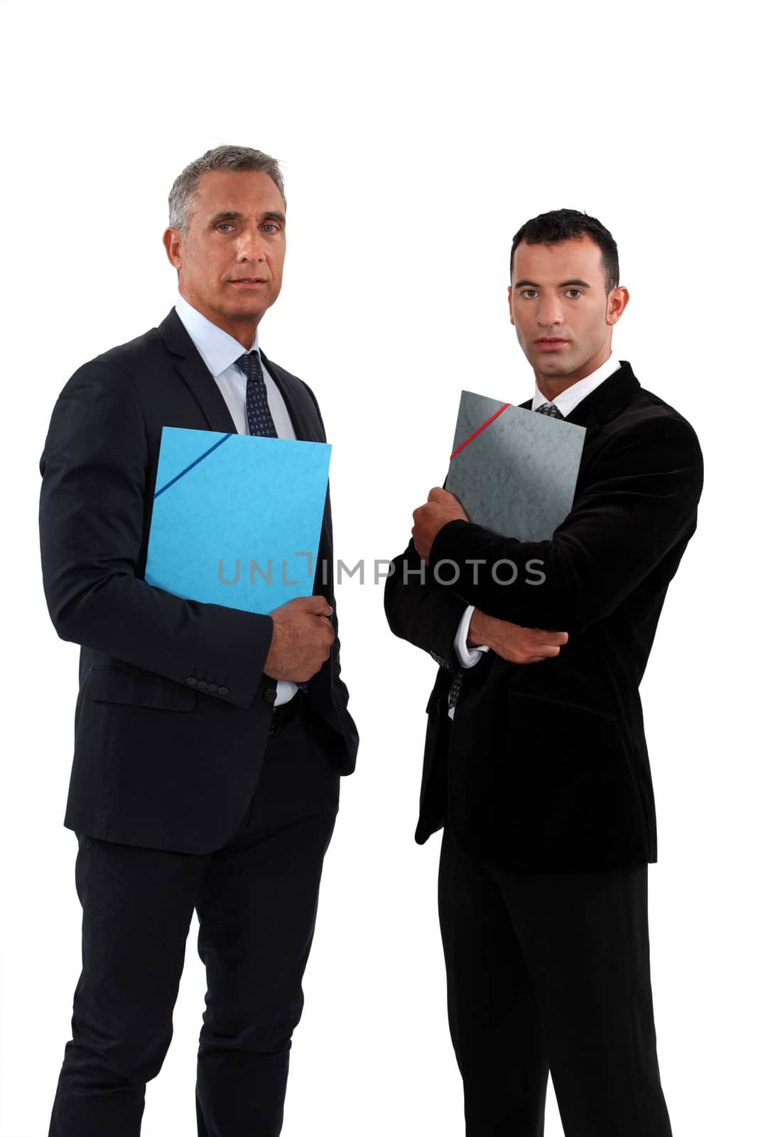 two businessmen holding folders
