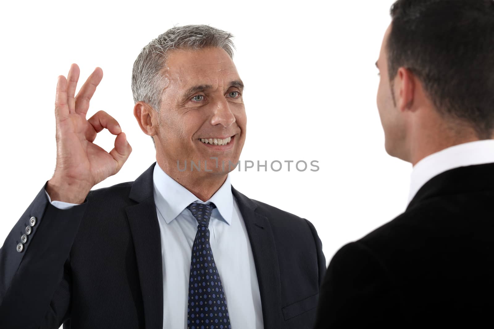happy businessman making an okay sign by phovoir