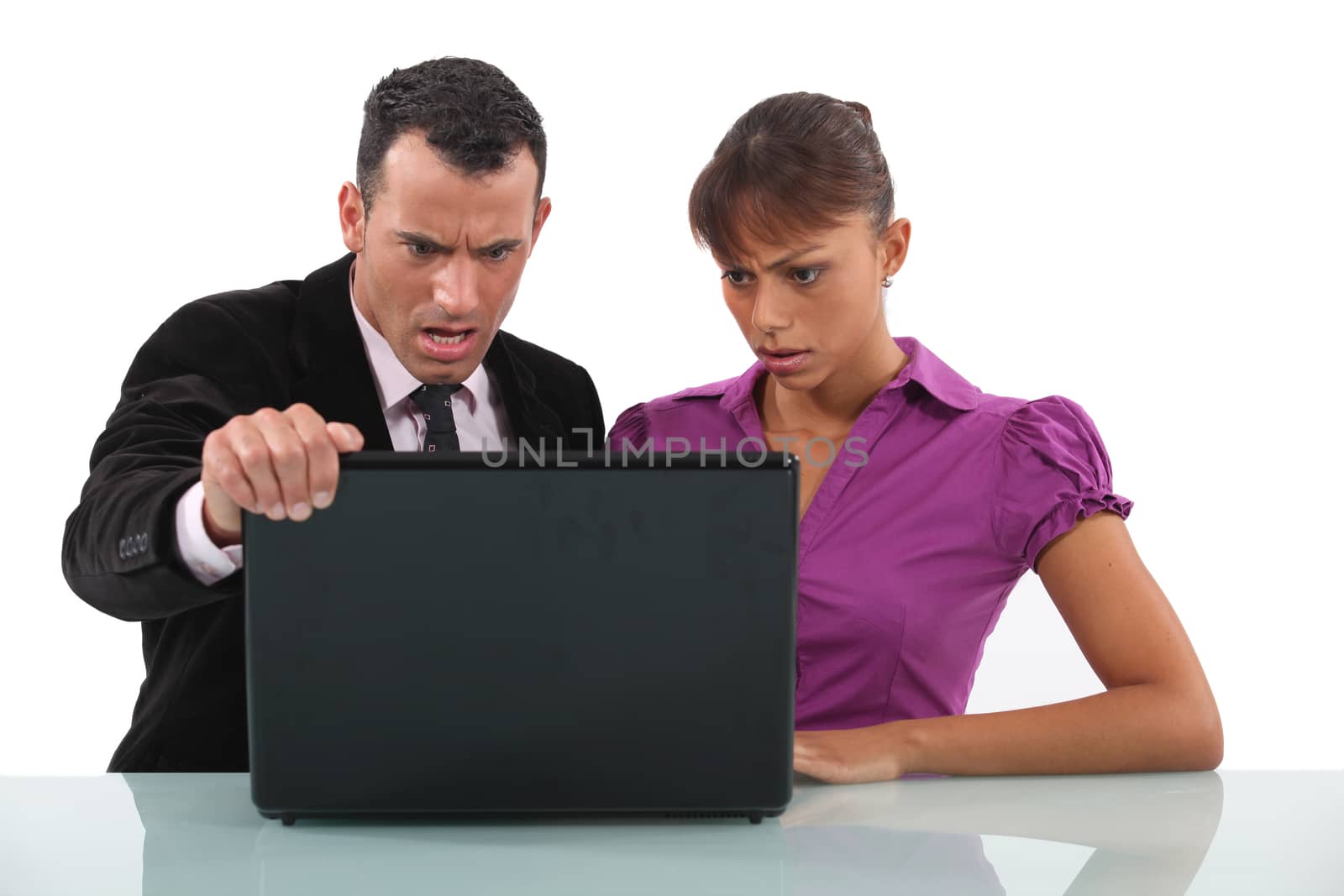 businessman and secretary getting angry over laptop