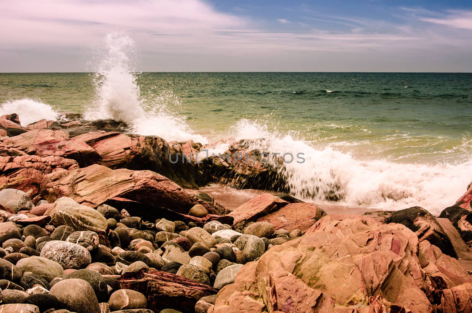 Splash against rocks at the shore of Porto Covo Beach on Alentejo, Portugal