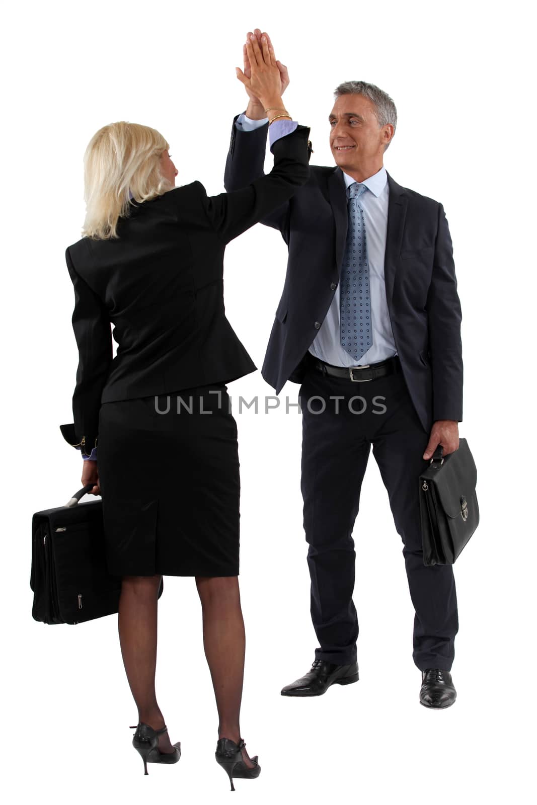 businessman and businesswoman clapping hands by phovoir