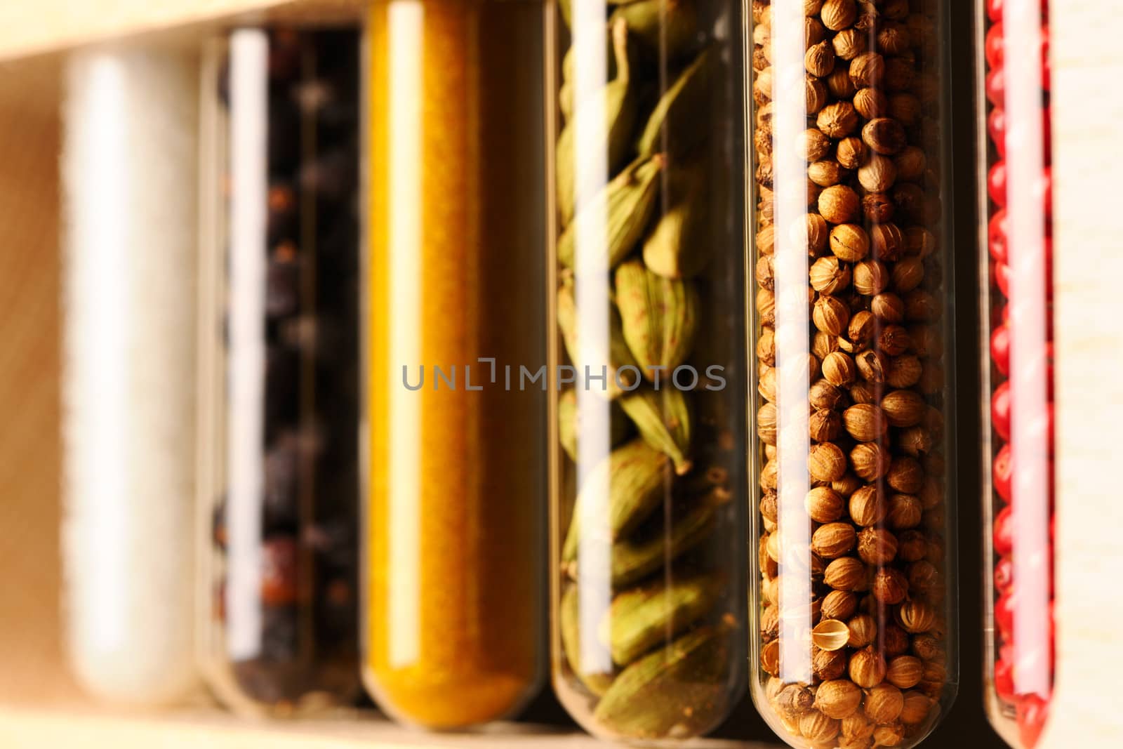 Spices in beakers against dark background