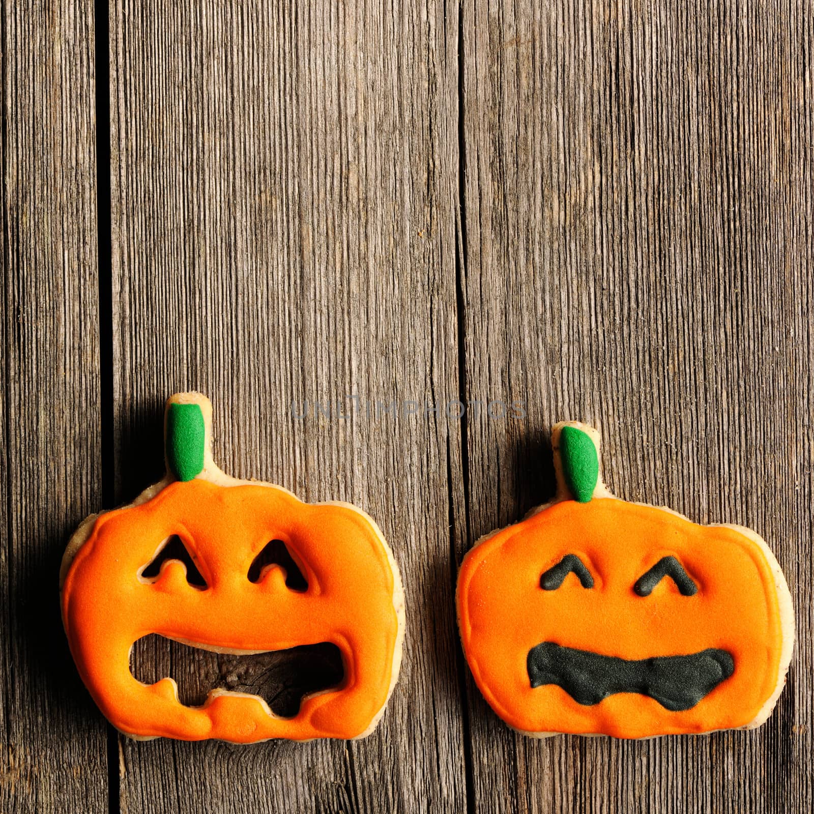 Halloween homemade gingerbread cookies over wooden table