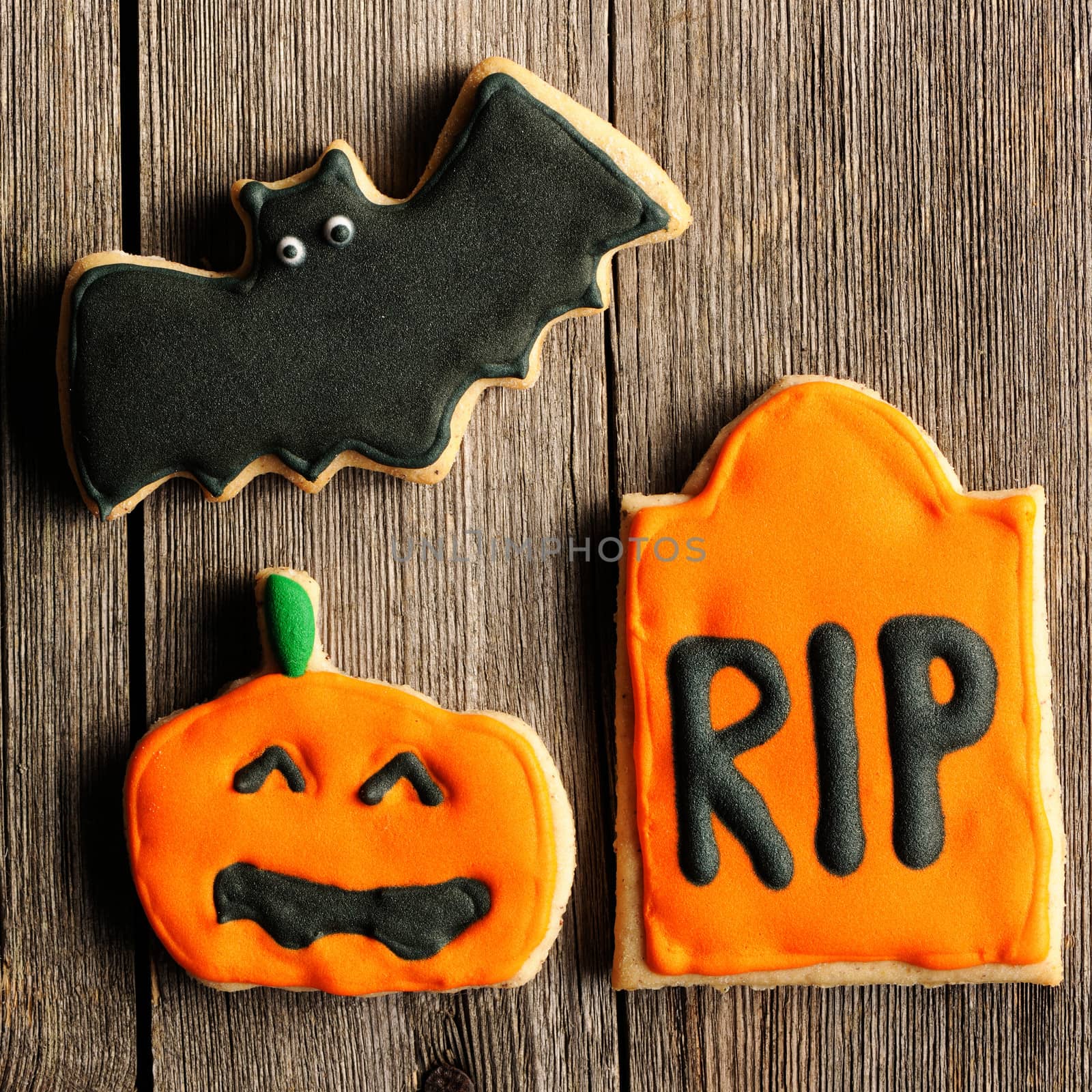 Halloween homemade gingerbread cookies over wooden table