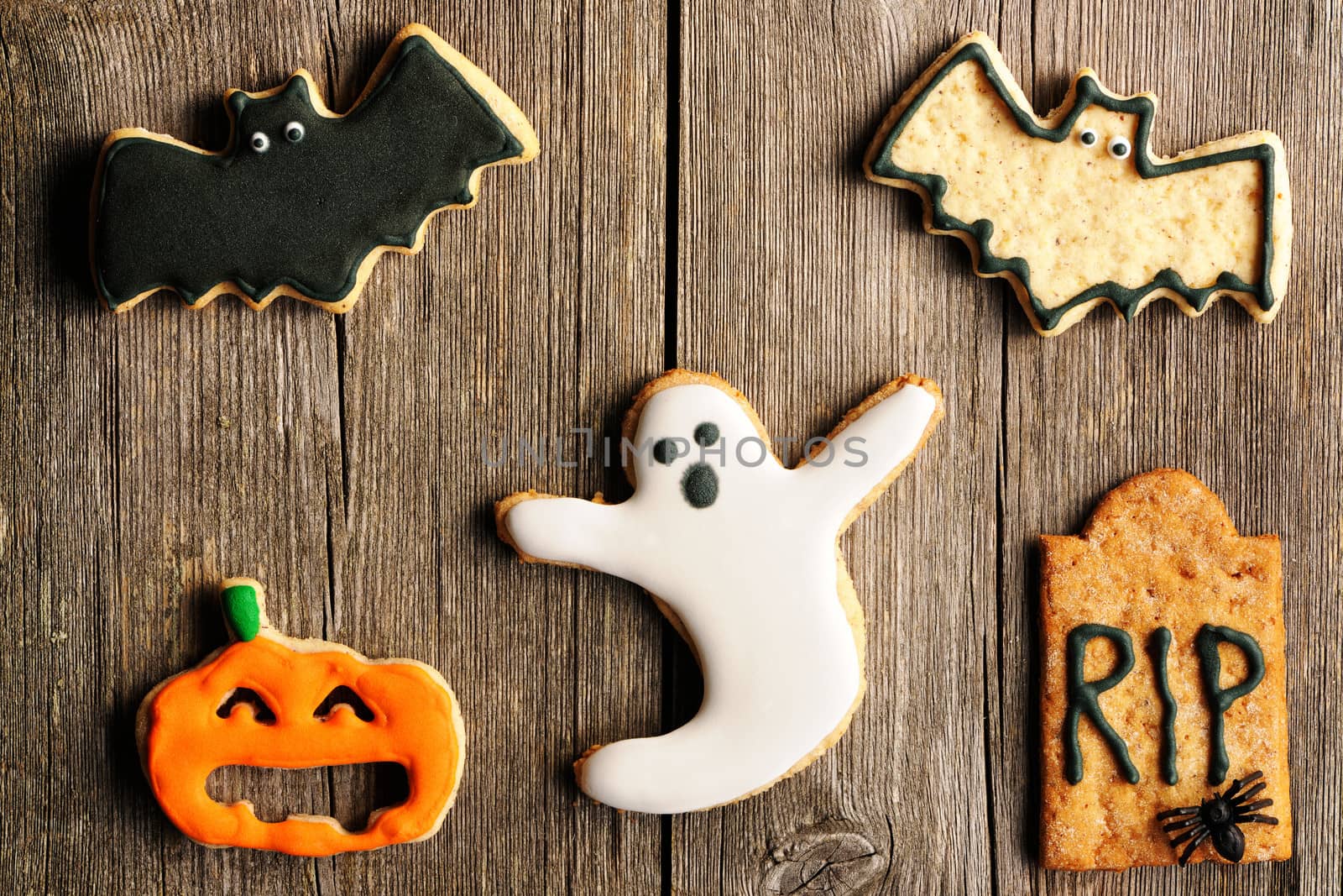 Halloween homemade gingerbread cookies over wooden table