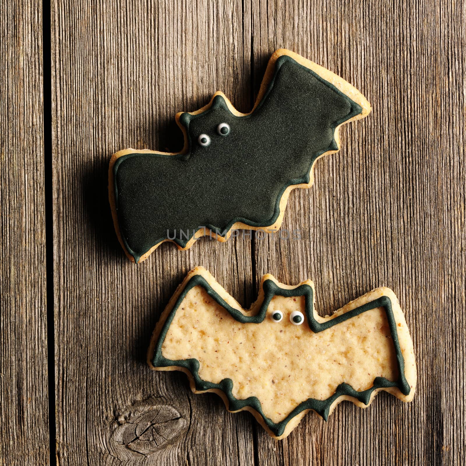 Halloween homemade gingerbread cookies over wooden table