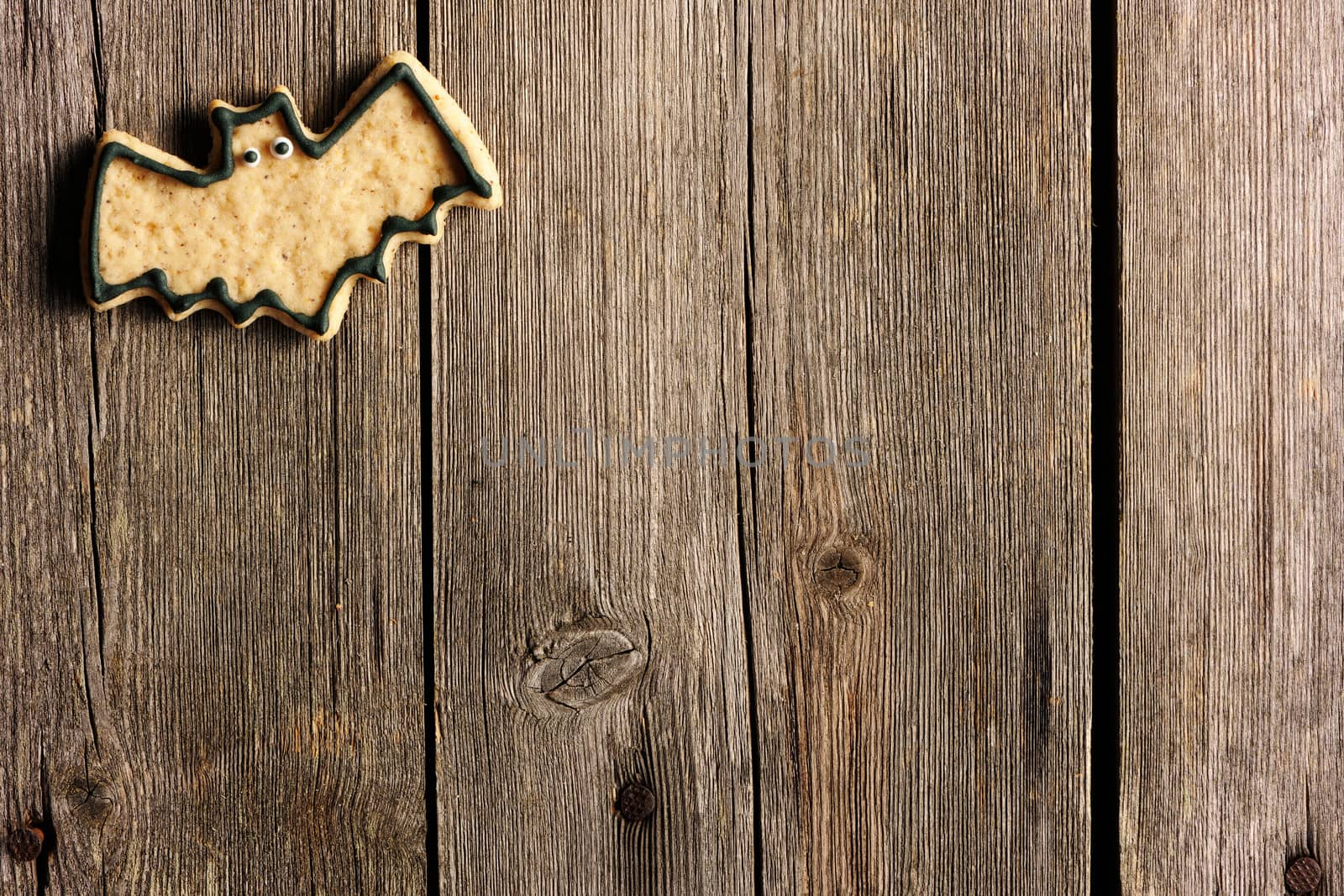 Halloween homemade gingerbread cookies over wooden table