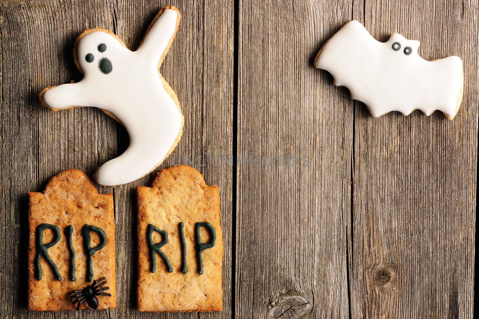 Halloween homemade gingerbread cookies over wooden table