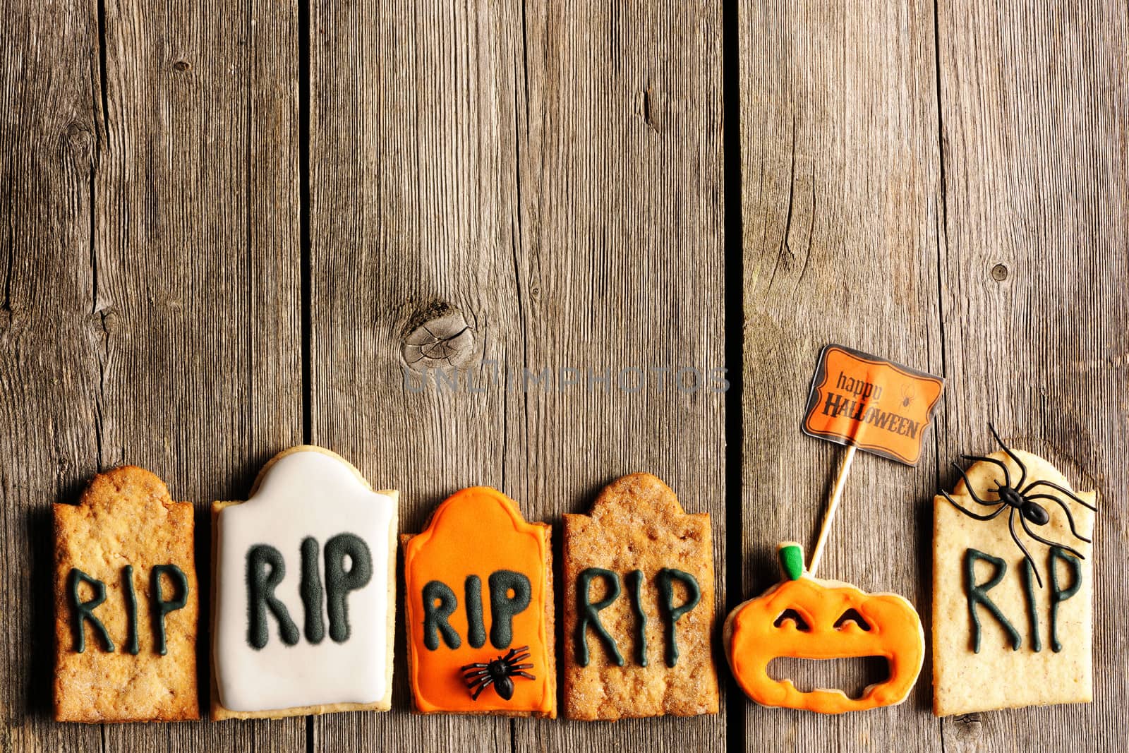 Halloween homemade gingerbread cookies over wooden table