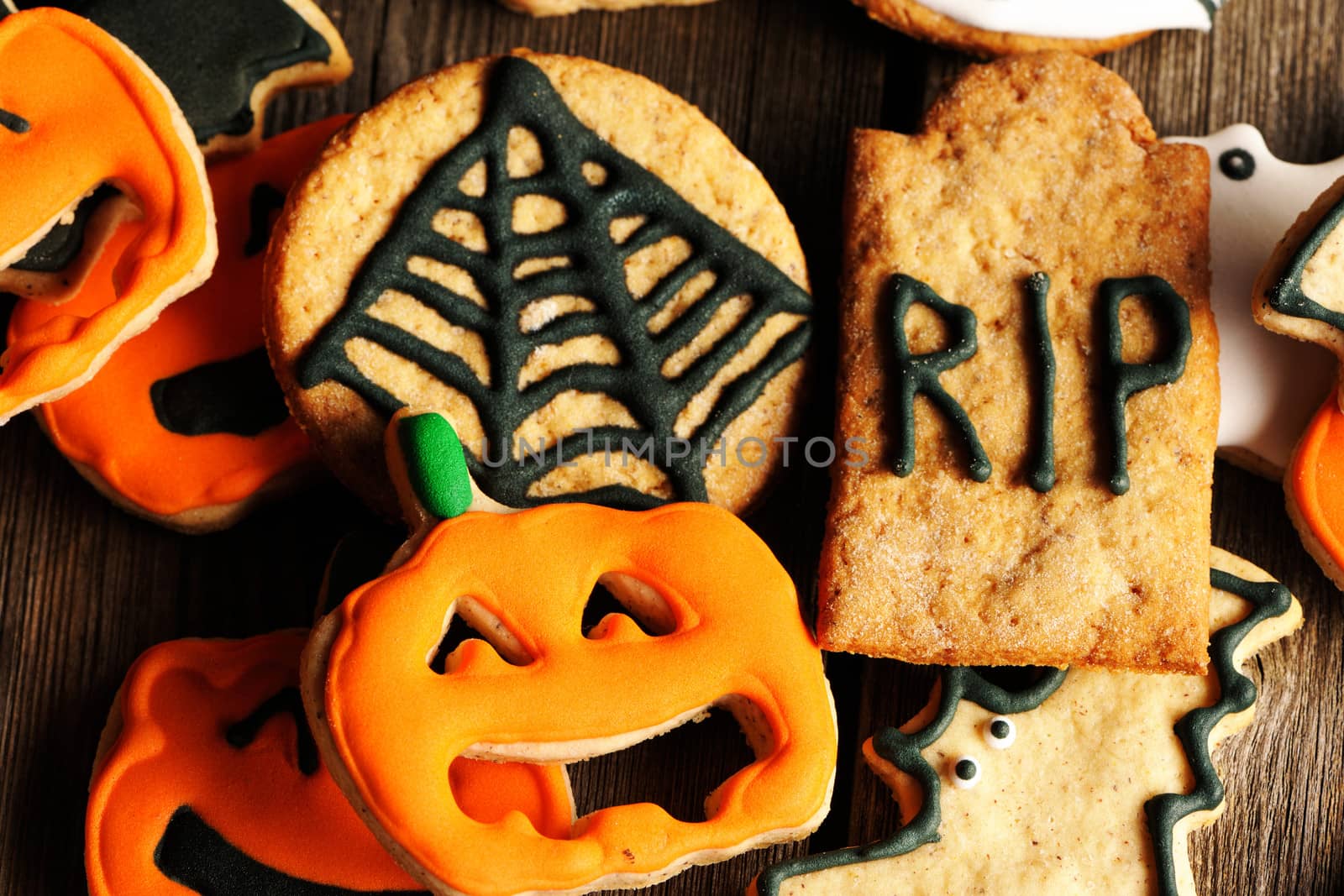 Halloween homemade gingerbread cookies over wooden table