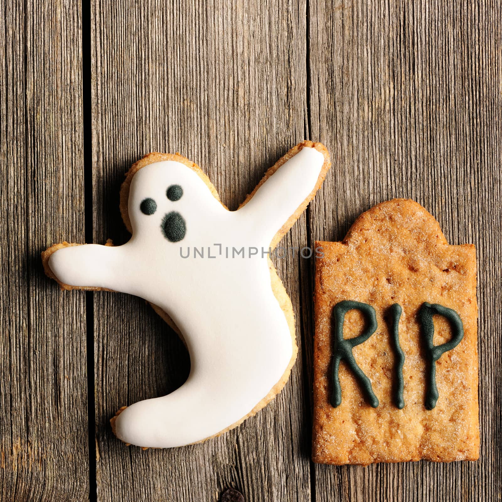 Halloween homemade gingerbread cookies over wooden table